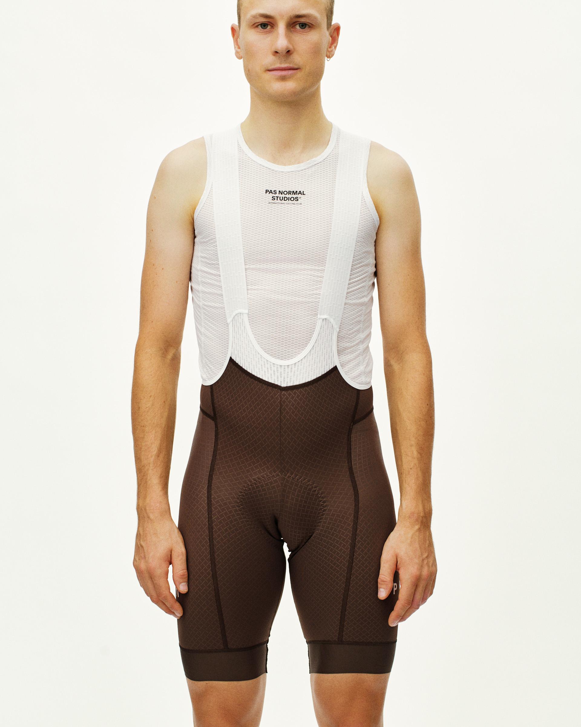 Light Brown Mechanism cycling bibs on model with white mesh bib and suspenders