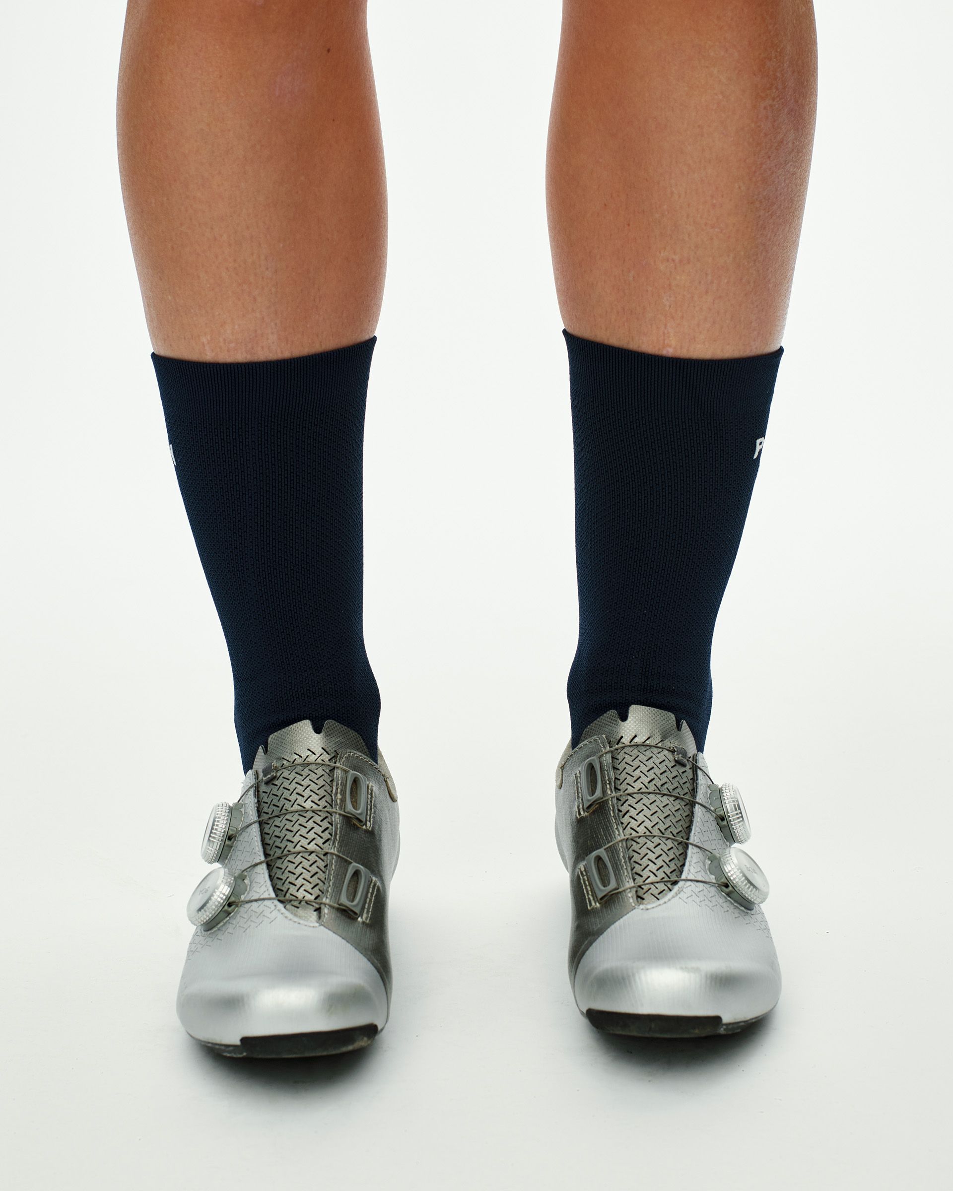 Navy Essential Race cycling socks on model, front view with white logo on ankle