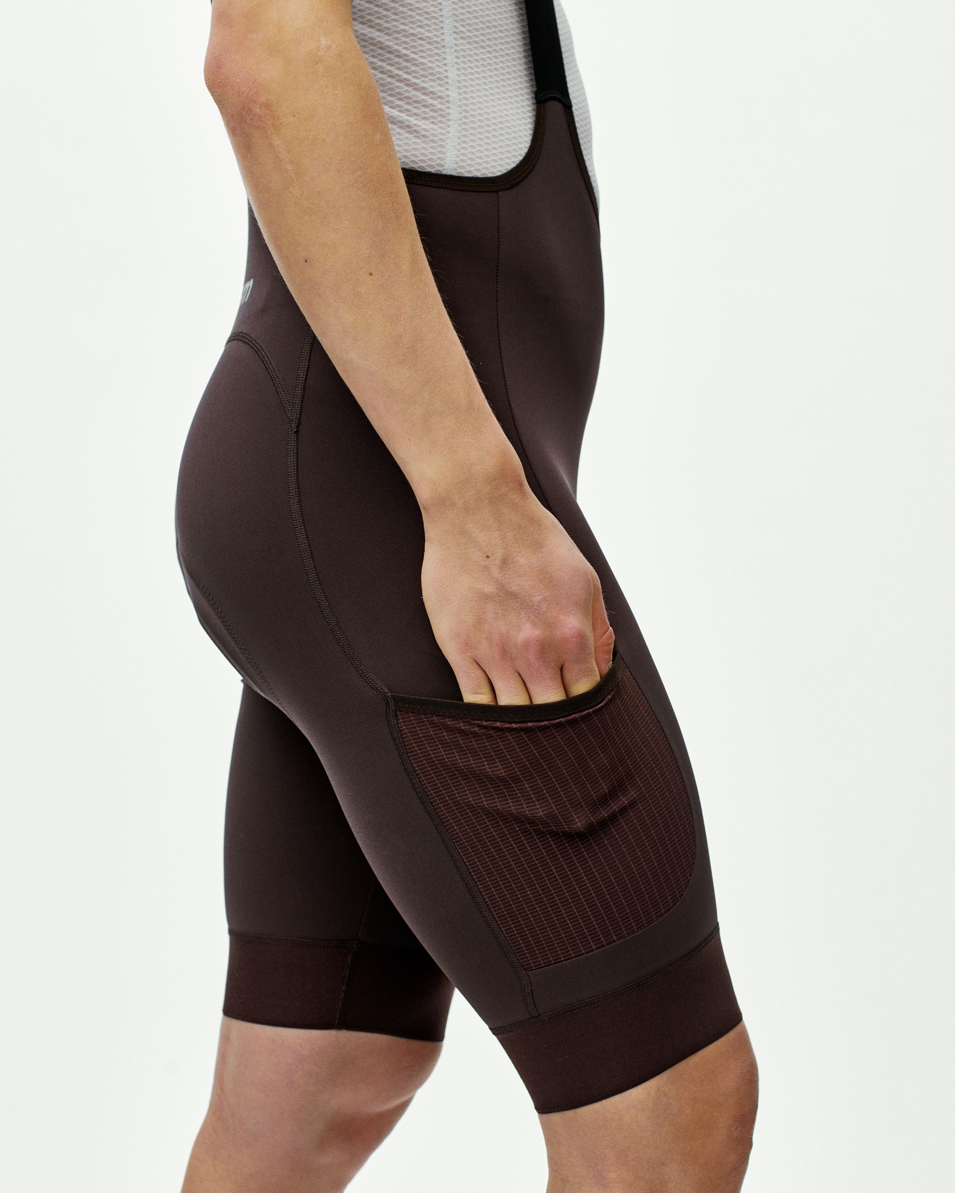 Dark Red Escapism Cargo bibs on model showing side mesh cargo pocket