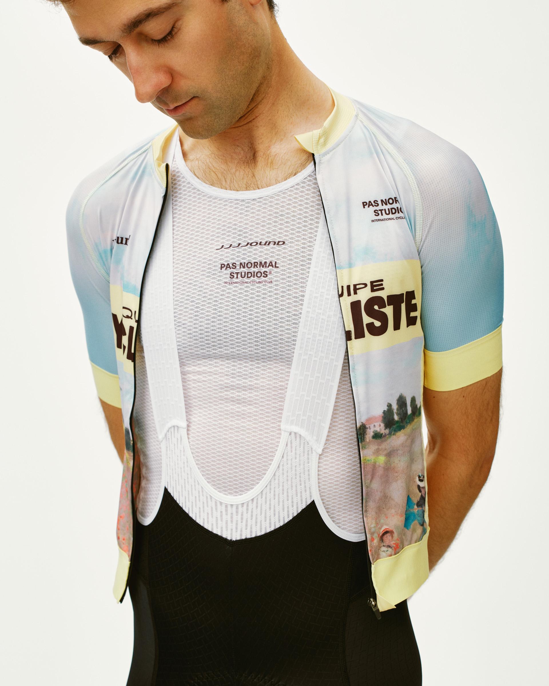 White JJJJound sleeveless base layer on model with mesh construction and branded chest print