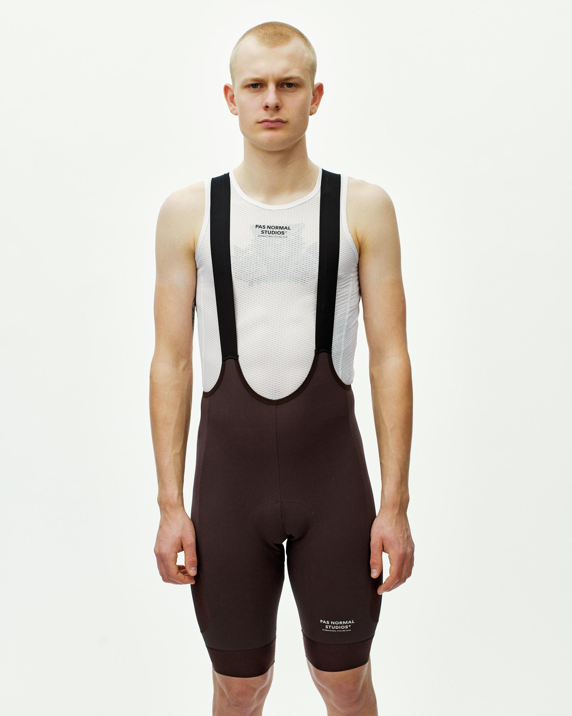 Dark Red Escapism Cargo cycling bibs on model with white mesh base layer