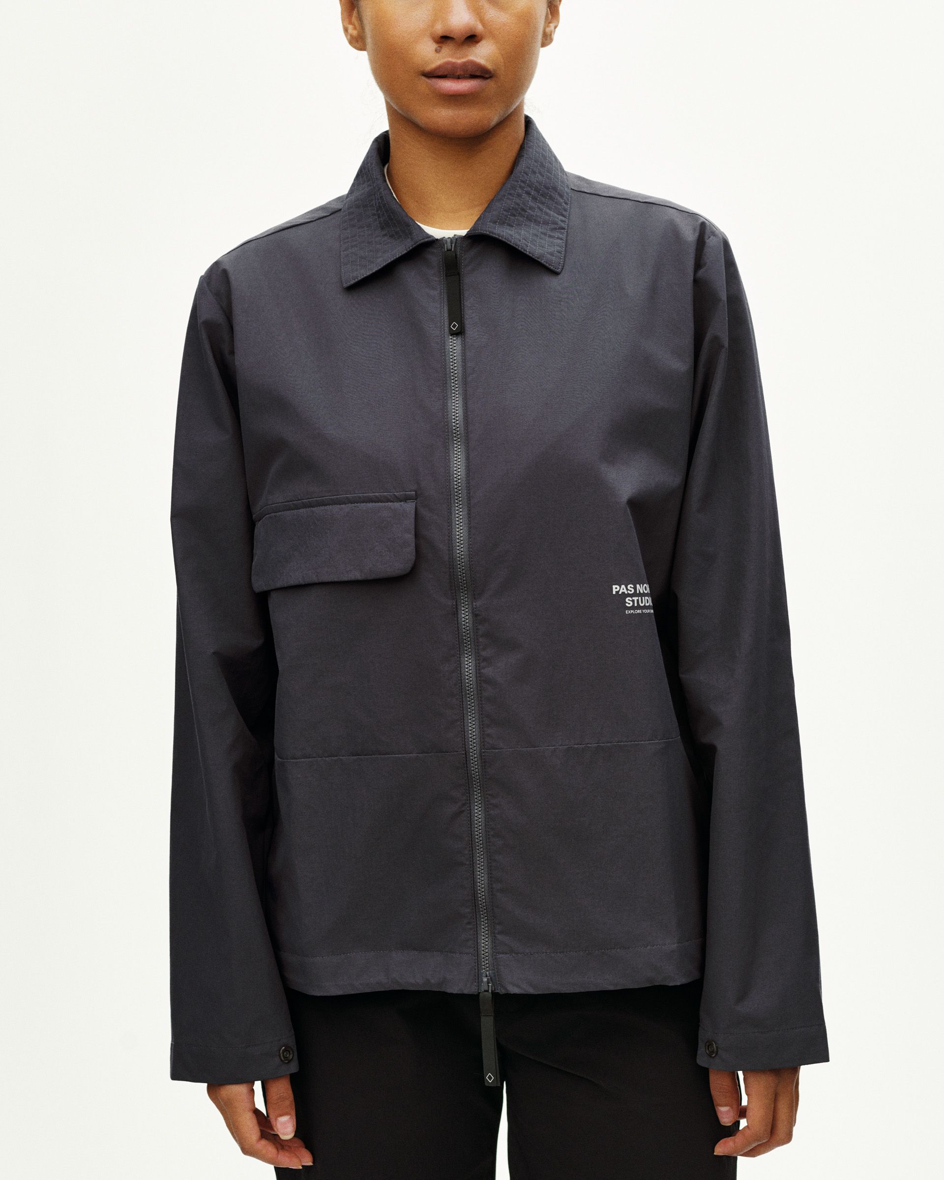 Grey Off-Race Utility jacket on model with chest pocket and full zip closure