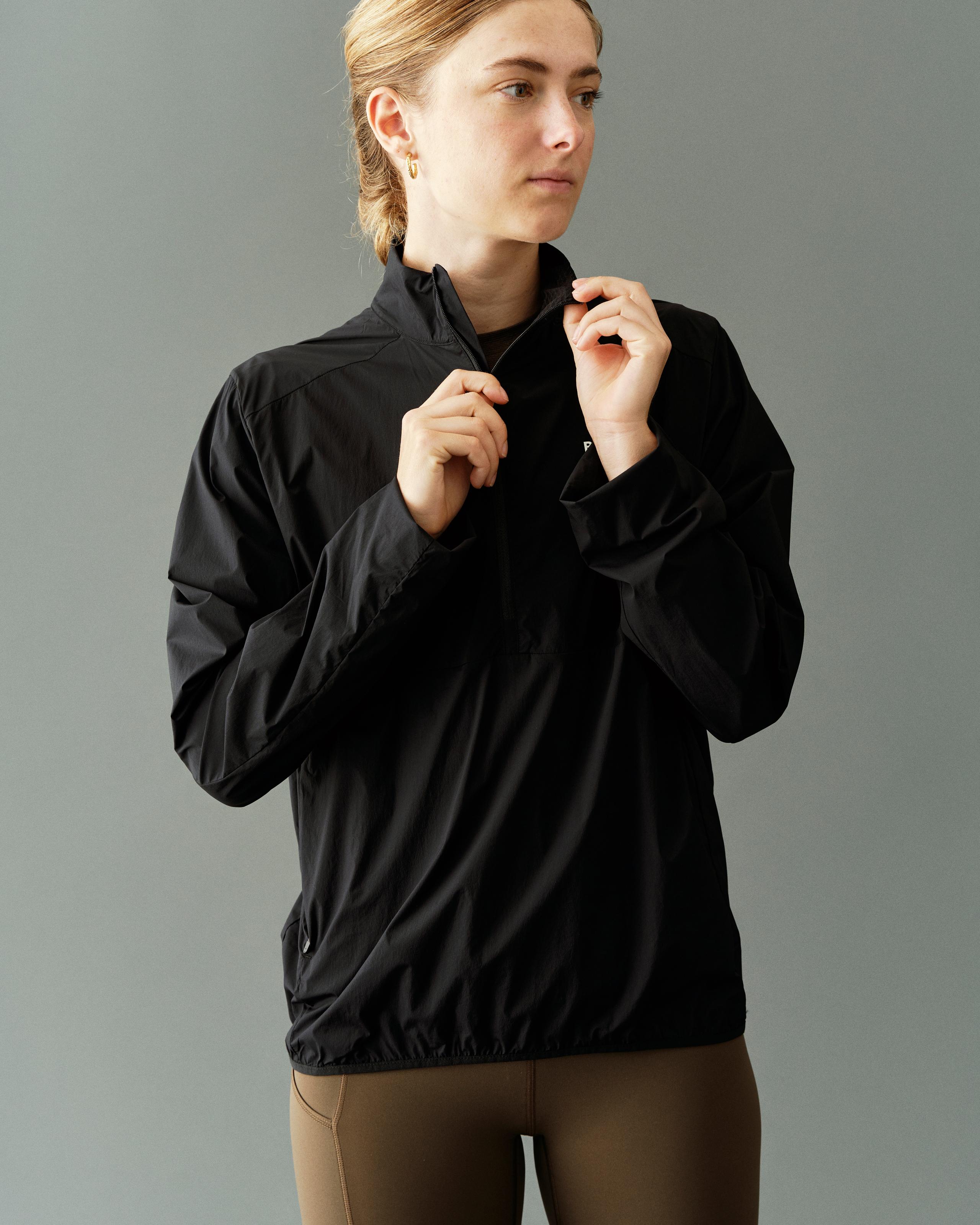 Black Balance Half Zip jacket on model with high collar and elasticated hem