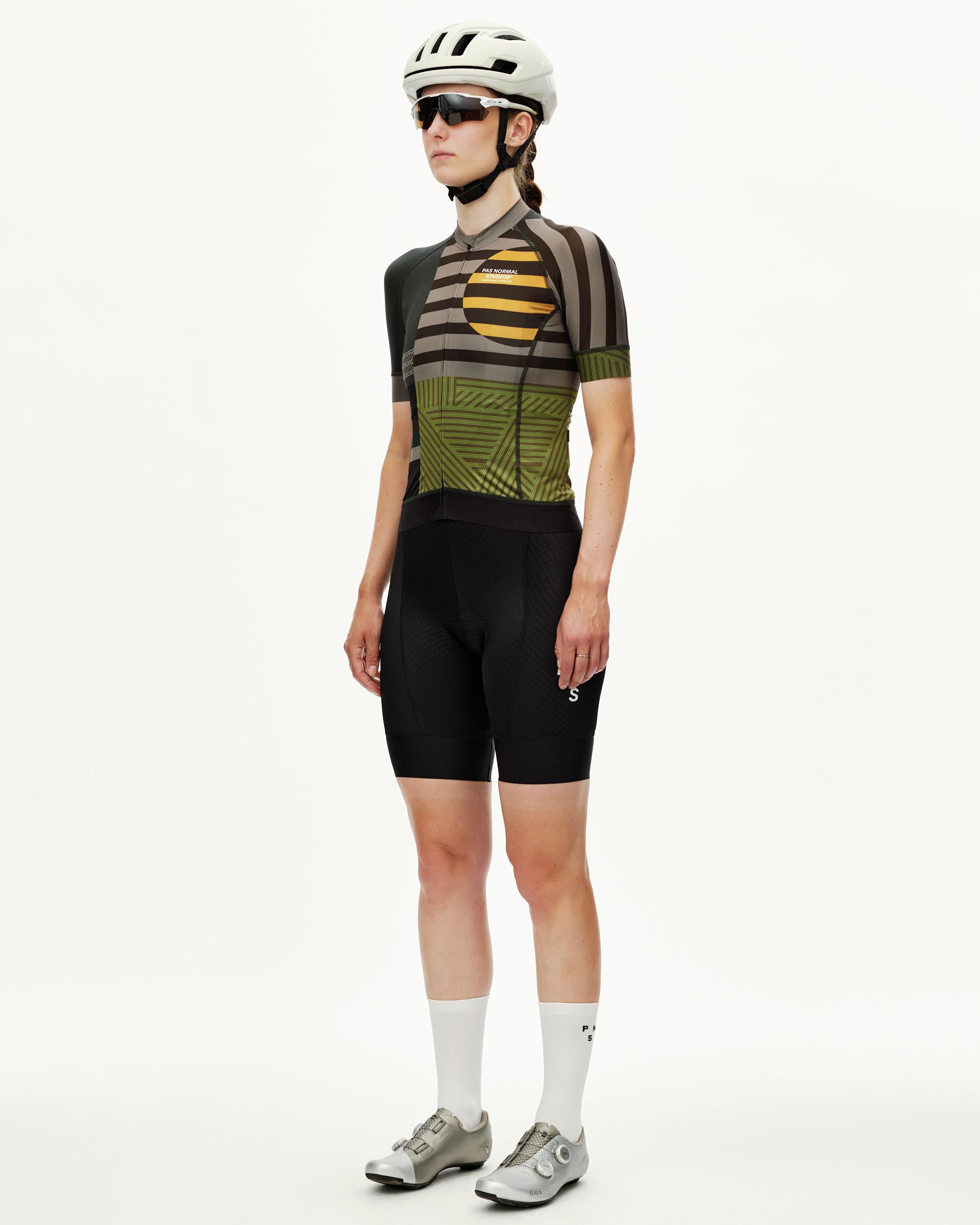 International Earth khaki Mechanism women's cycling jersey on model, three-quarter front view with geometric stripe print