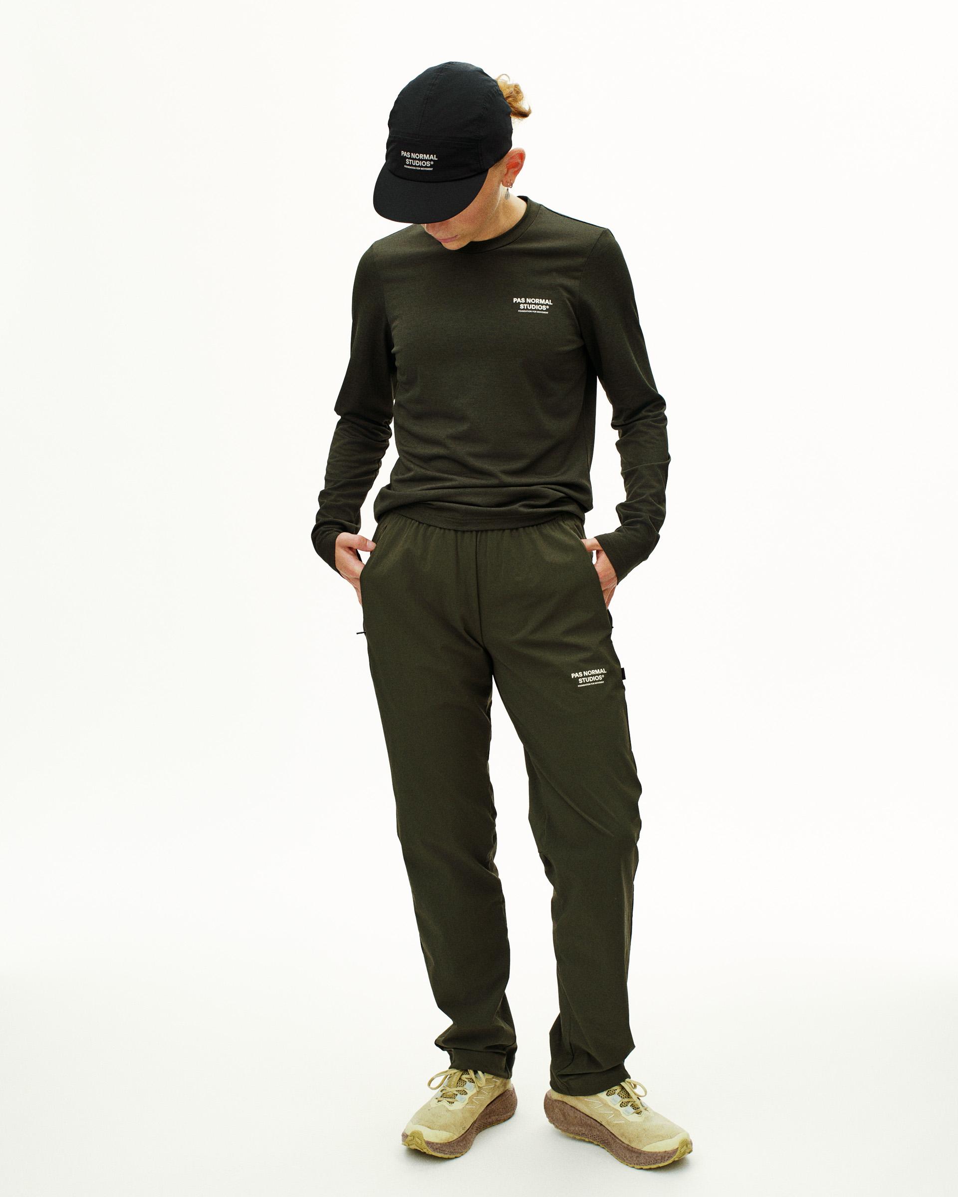 Dark Olive Balance pants on model with elastic waistband and side pockets