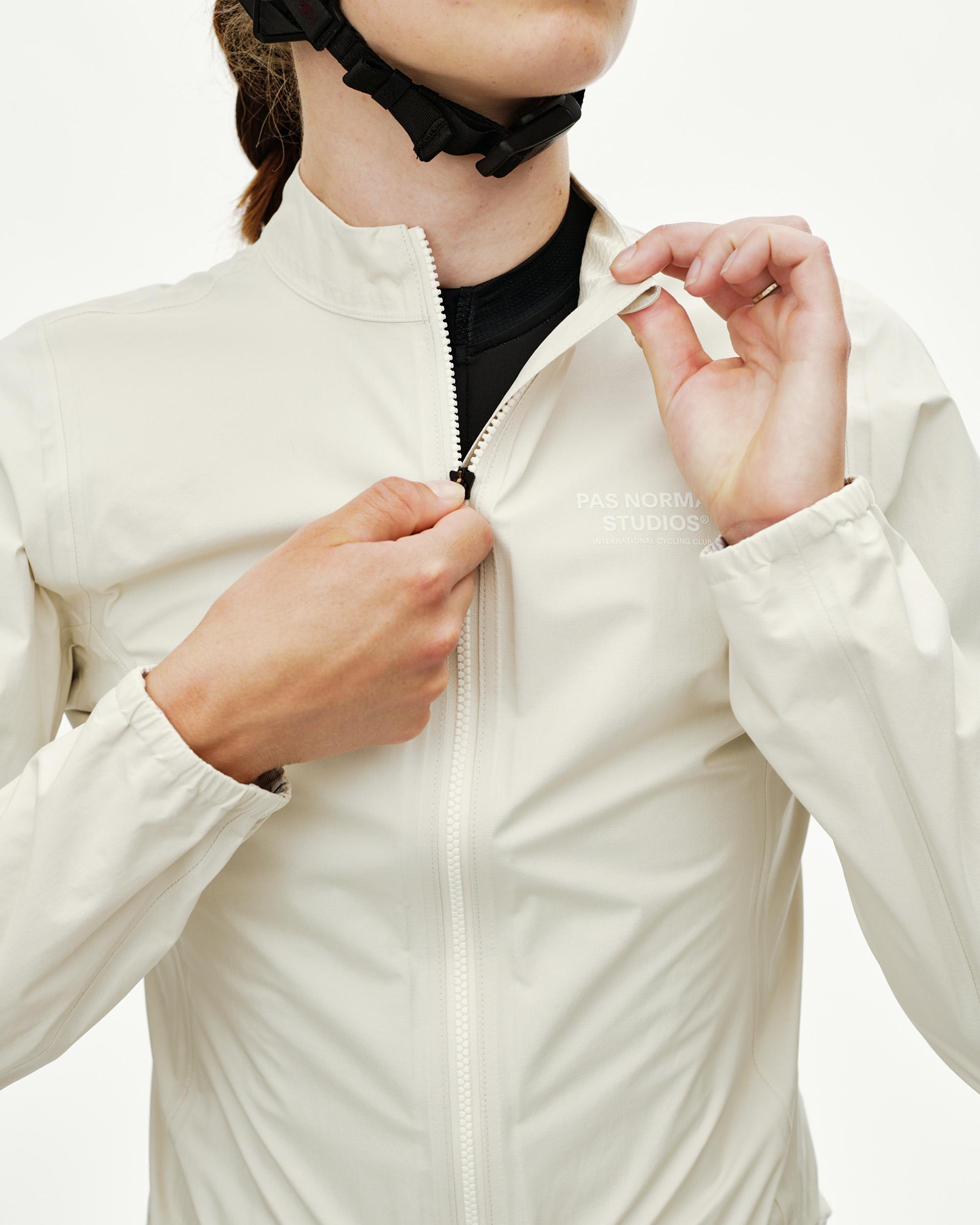Off White Mechanism women's cycling rain jacket, front detail on model showing full zip and tonal chest print