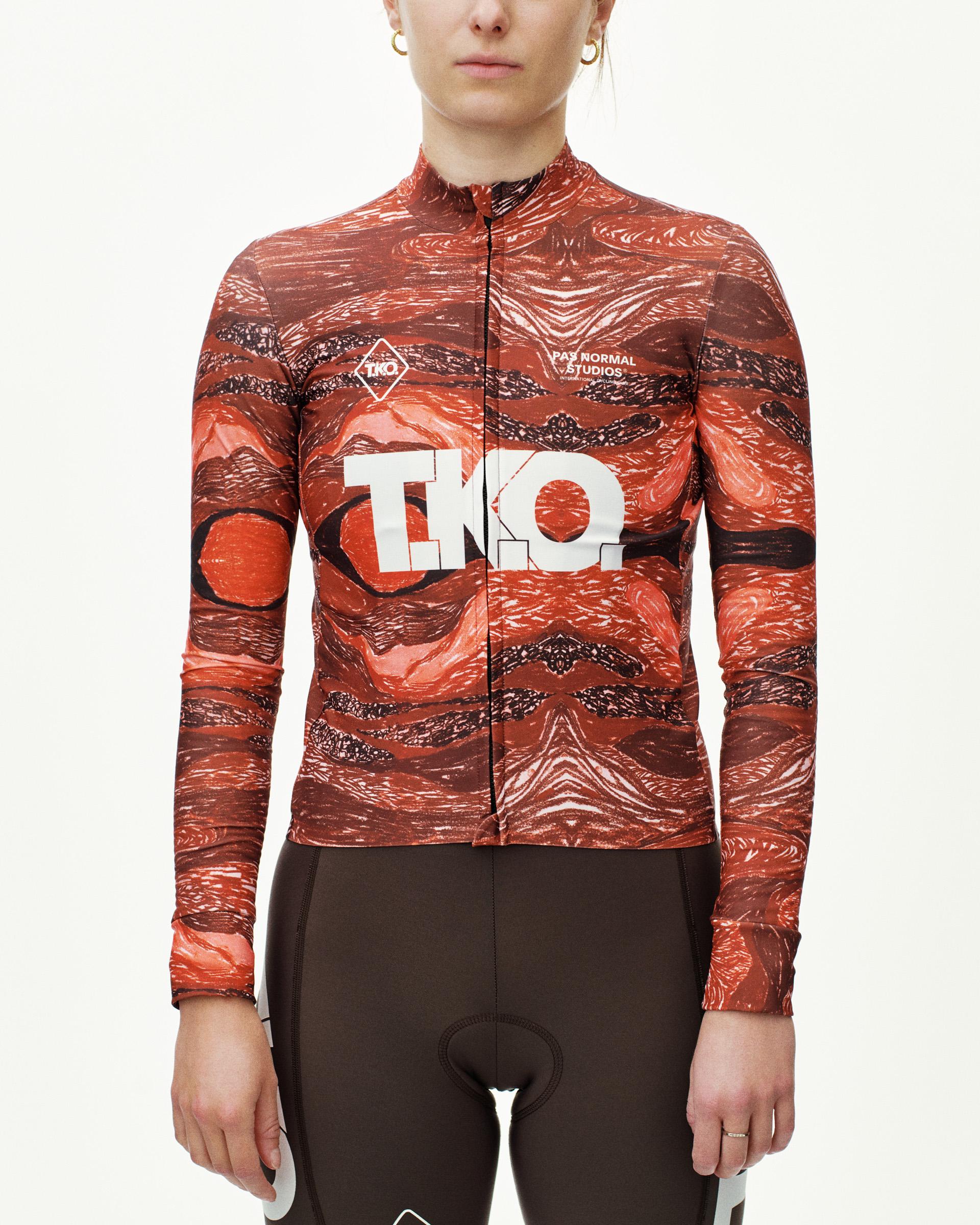 Red T.K.O. Mechanism long sleeve cycling jersey on model, front view with abstract swirl AOP and white chest logo
