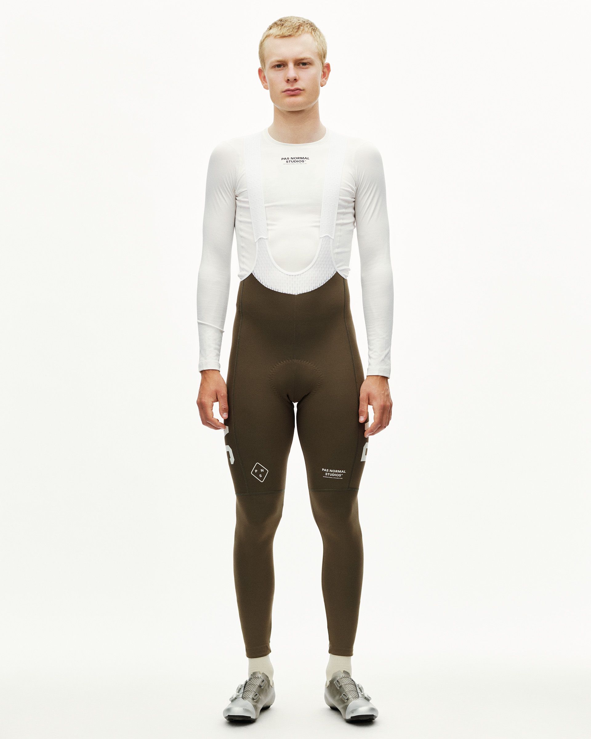 Dark Earth khaki PAS Mechanism Thermal cycling long bibs on model, front view with white leg print