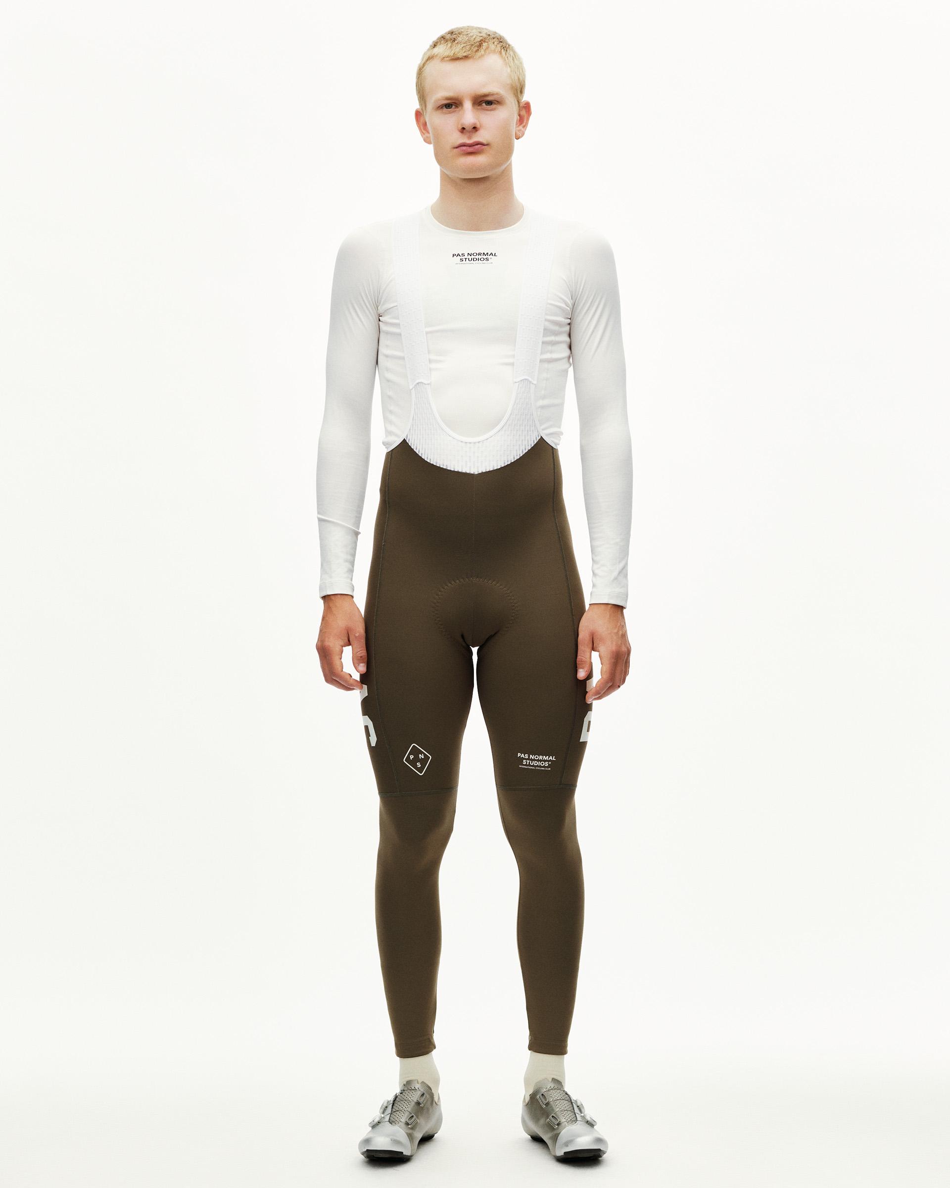 Dark Earth khaki PAS Mechanism Thermal cycling long bibs on model, front view with white leg print