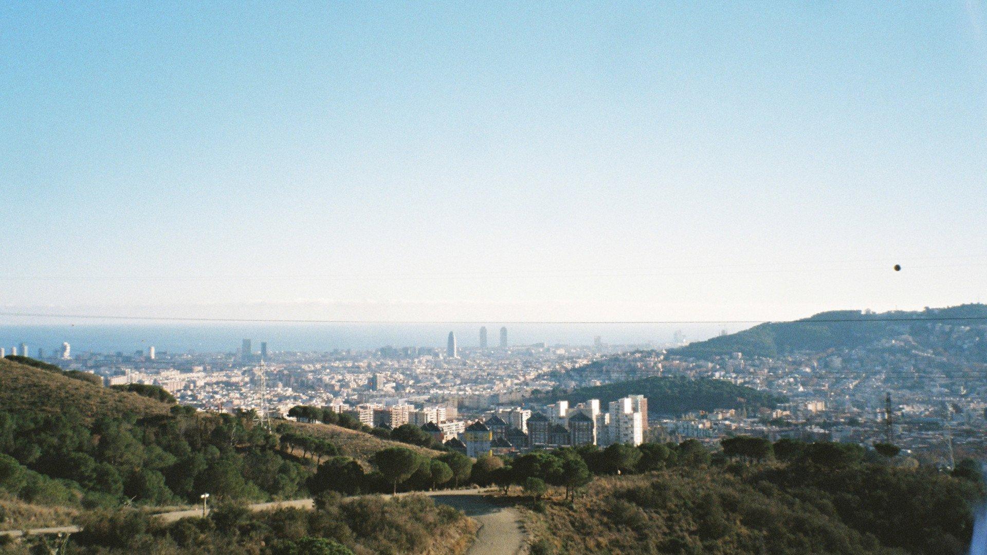 Panoramic view of Barcelona cityscape from hillside cycling route