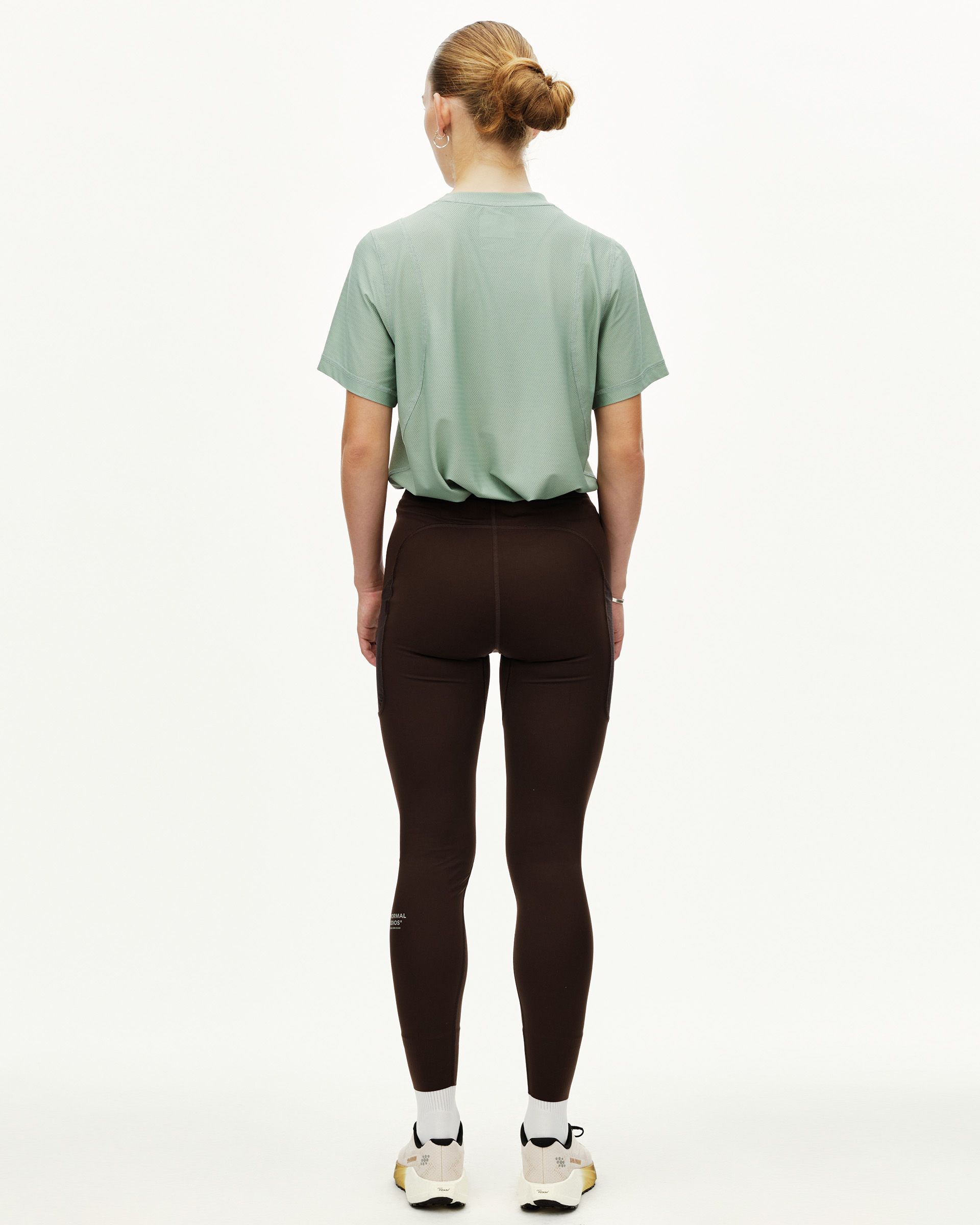 Dark Coffee brown Balance women's long tights on model, rear view with side panel detail