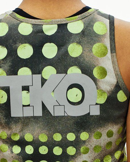Green T.K.O. Balance singlet, rear view on model with large polka dot print and T.K.O. logo