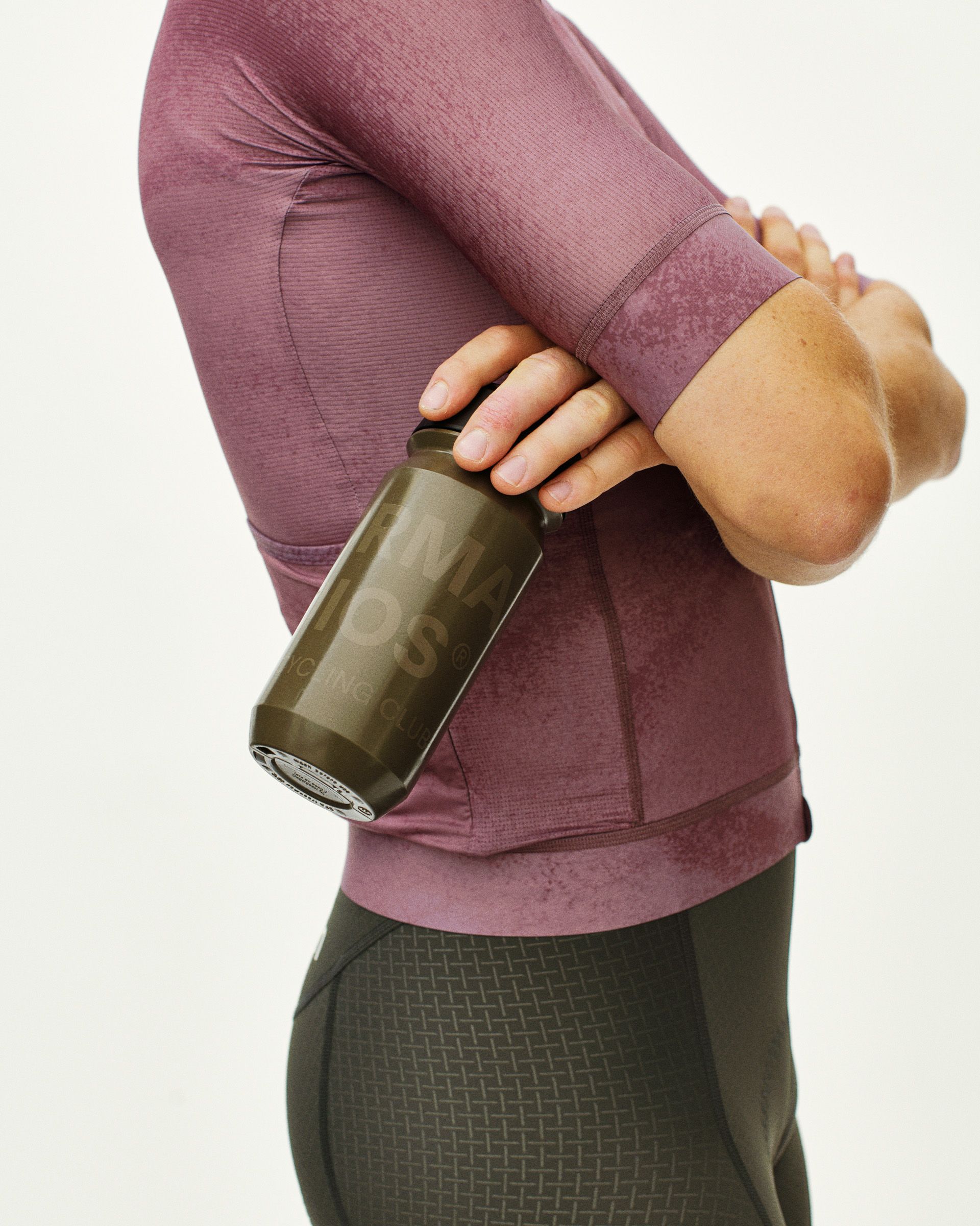 Brown Essential Logo water bottle on model with green tinted glass design