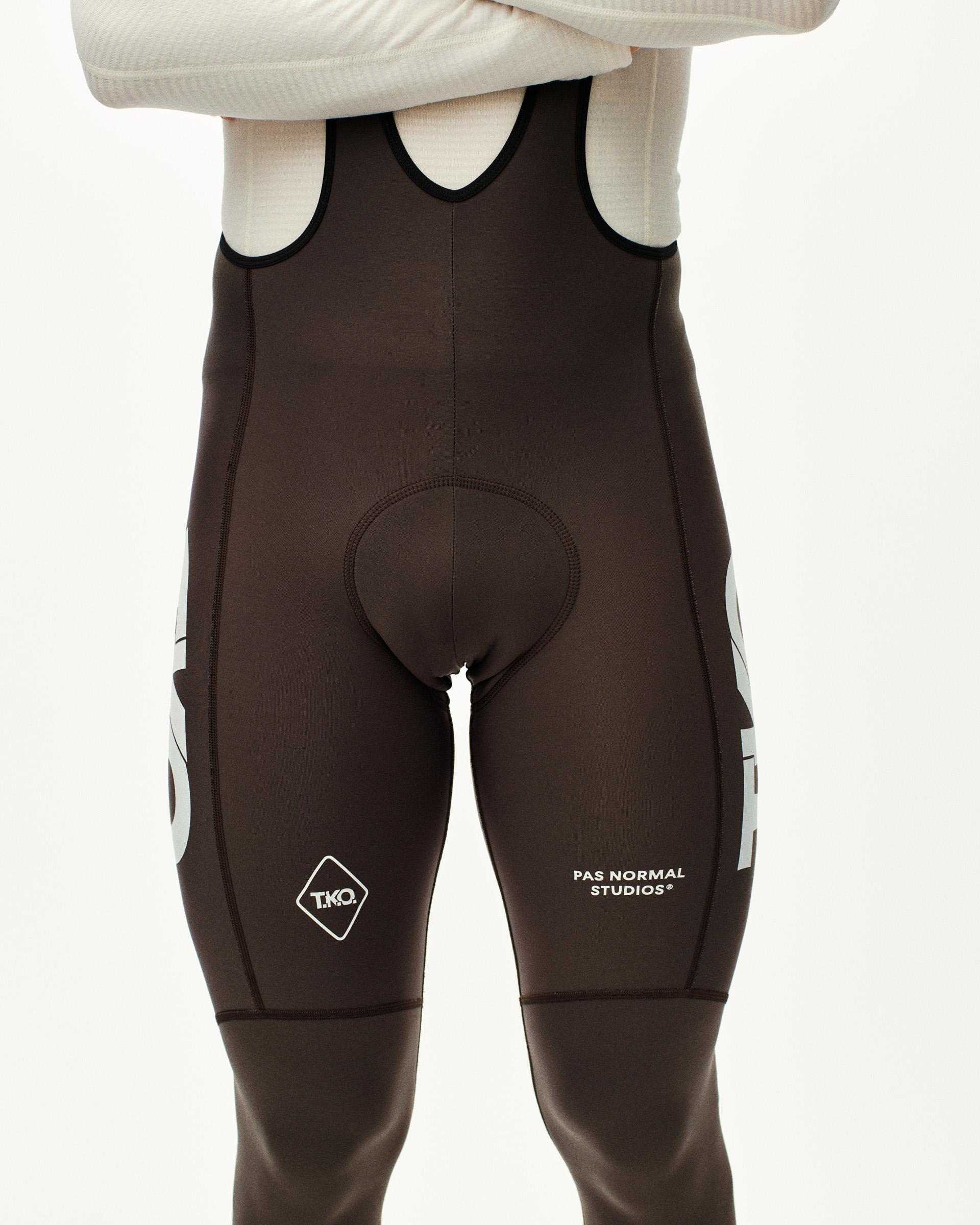 Dark Purple T.K.O. Essential Thermal Long cycling bibs, front view on model with white side panels