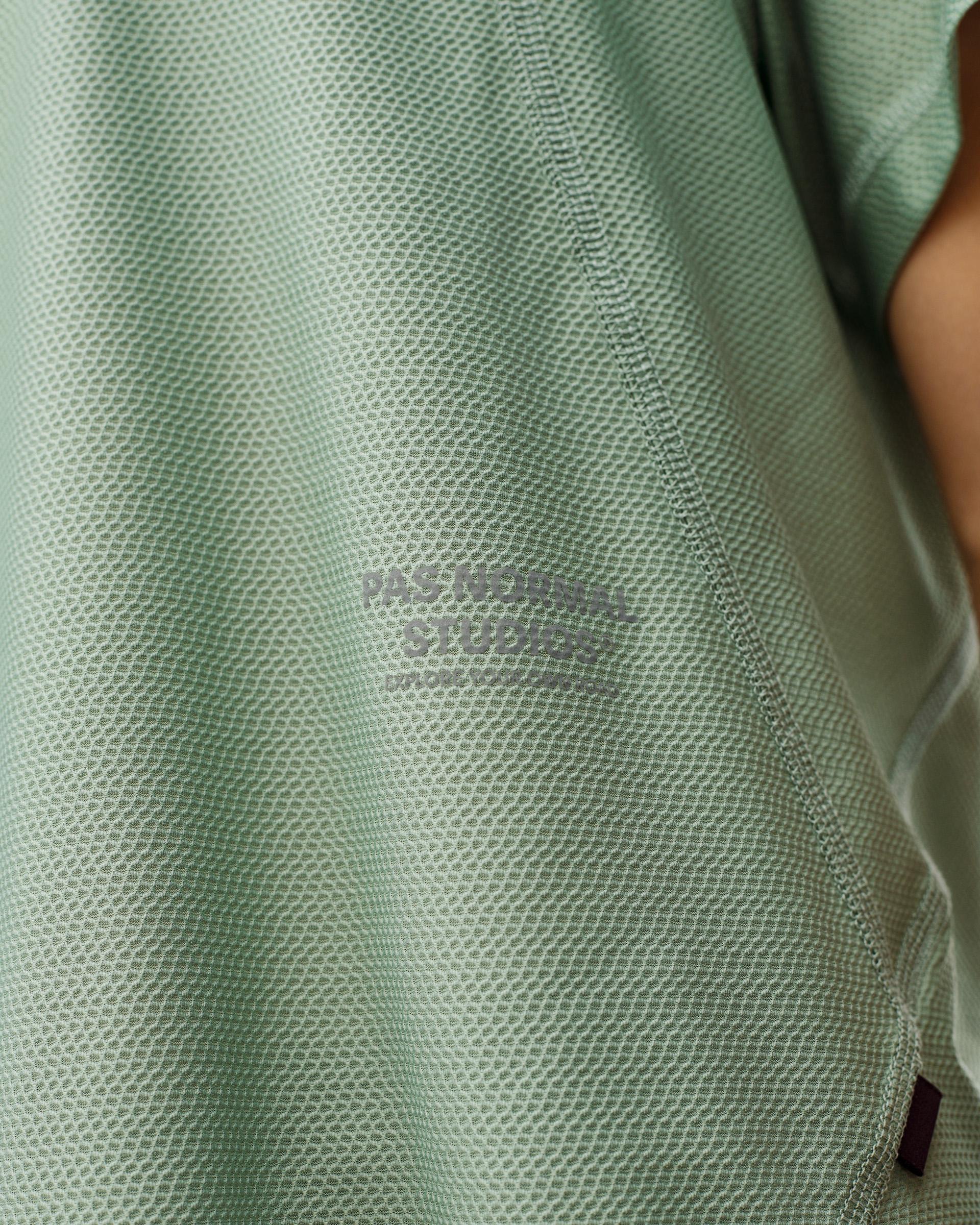 Green Sage Balance women's T-shirt, close-up detail on model showing textured mesh fabric and tonal chest print
