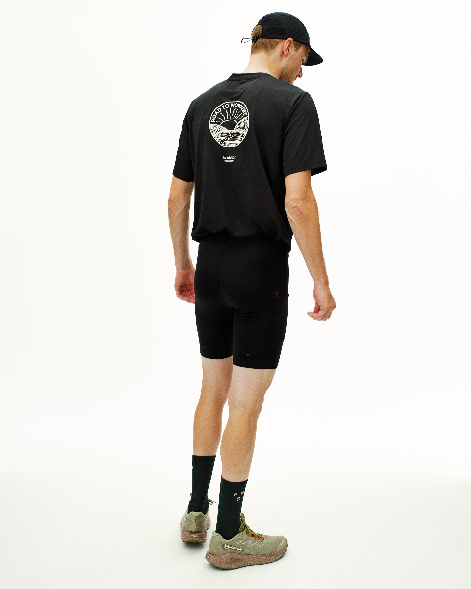 Black Balance short tights on model, rear view with elastic waistband