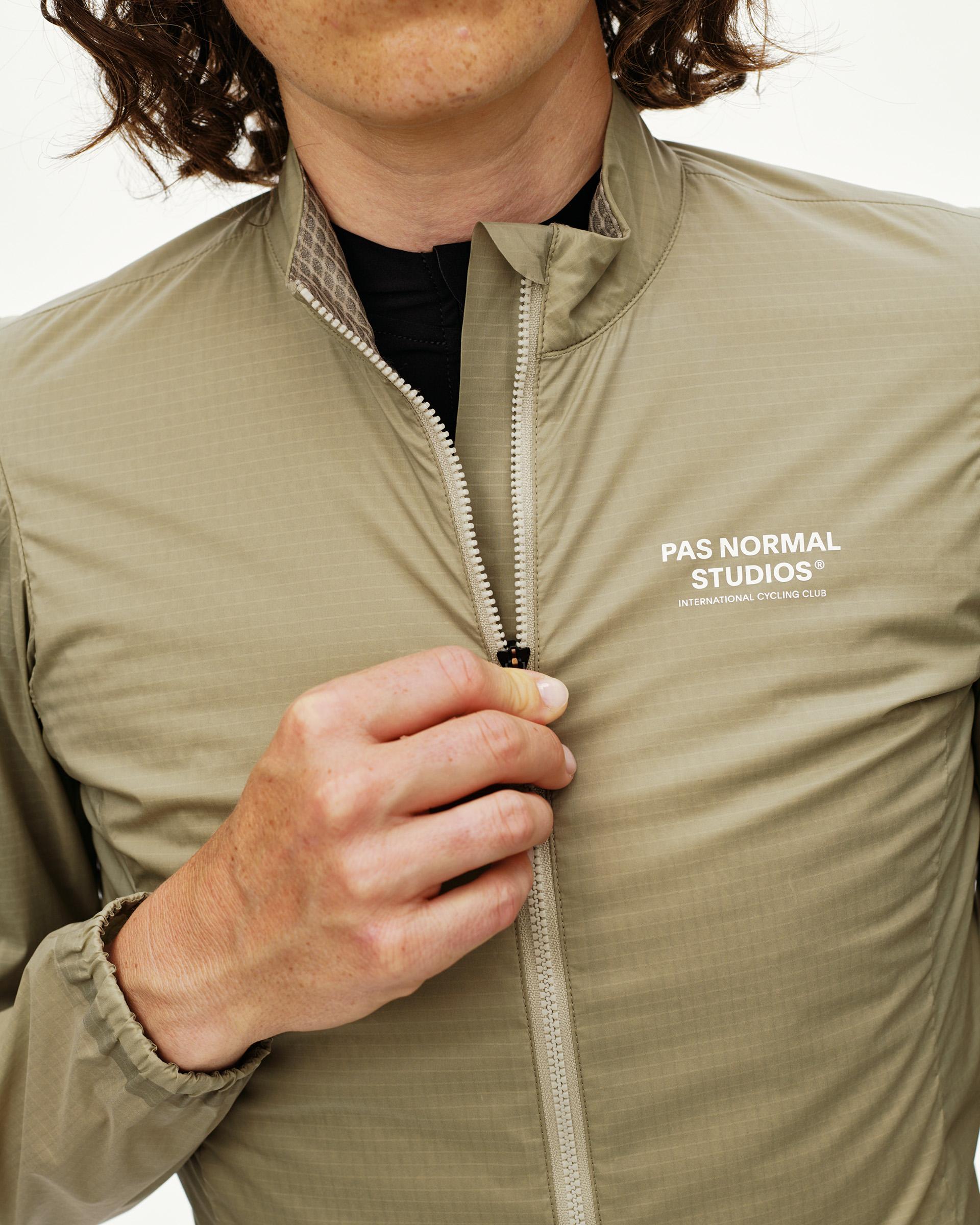 Grey Sage Essential Insulated cycling jacket on model, front detail with full zip and white chest logo