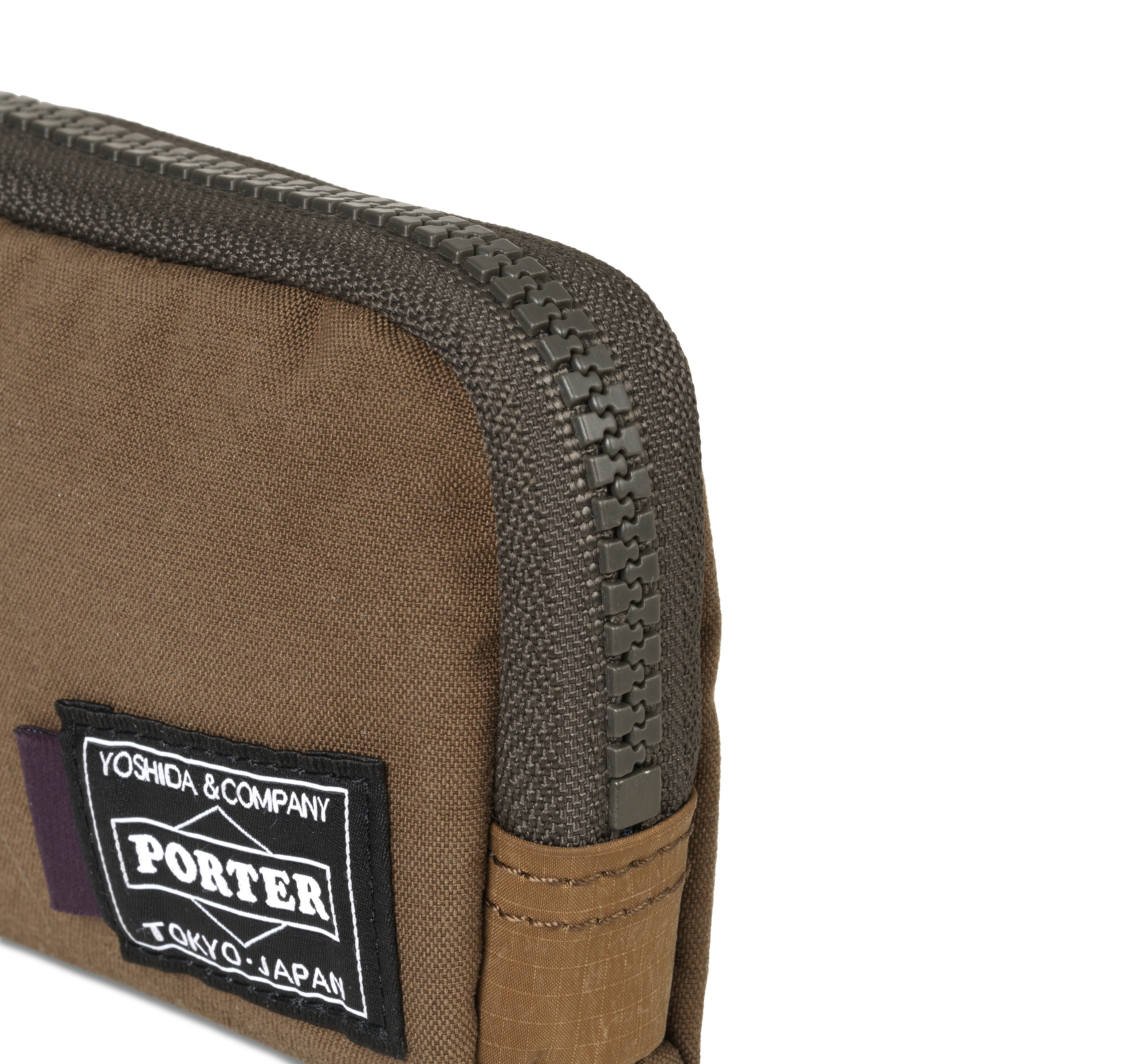 Light Brown Porter-Yoshida coin case, detail view showing dark zip and woven logo patch