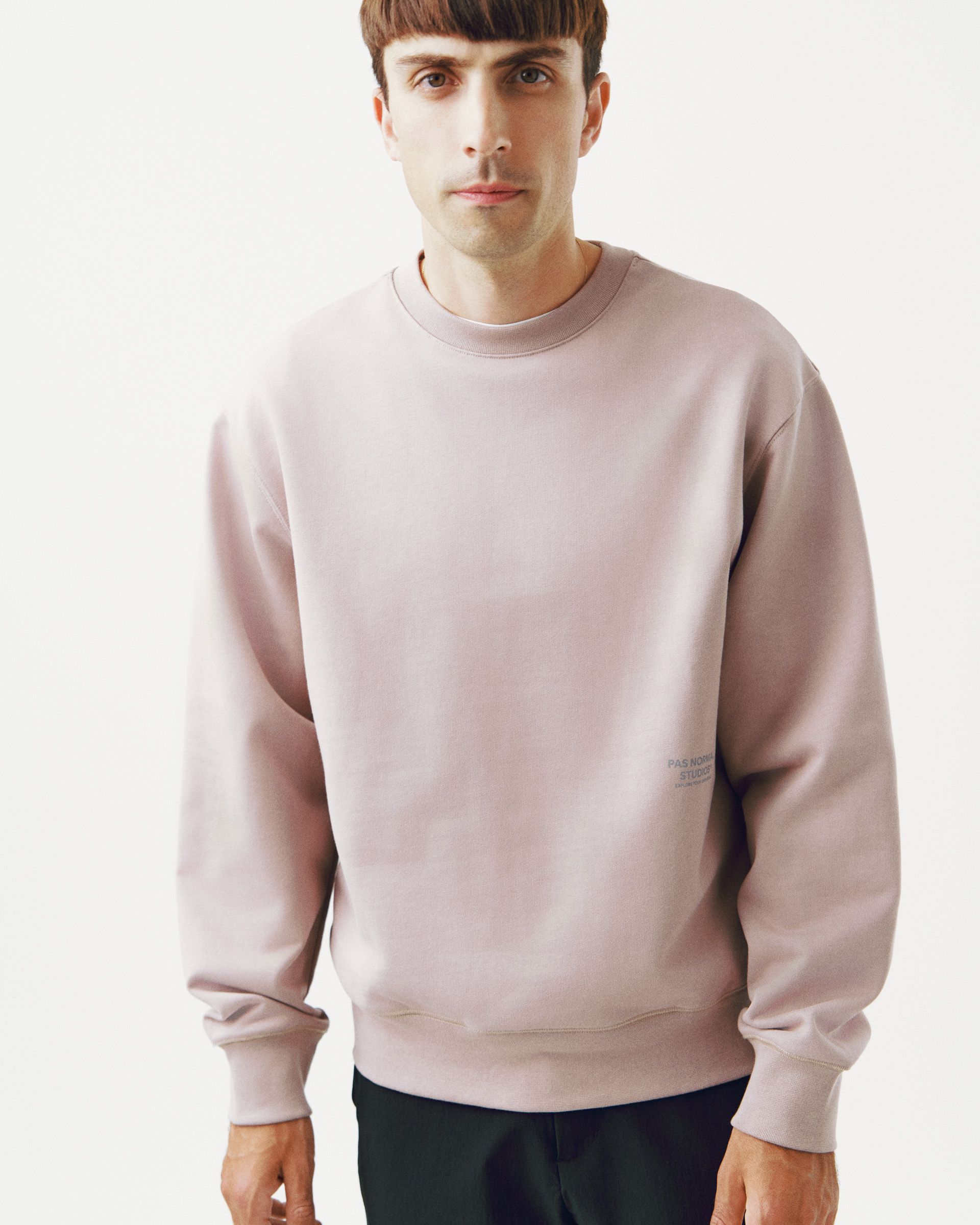 Pink Off-Race sweatshirt on model, front view with small grey chest logo