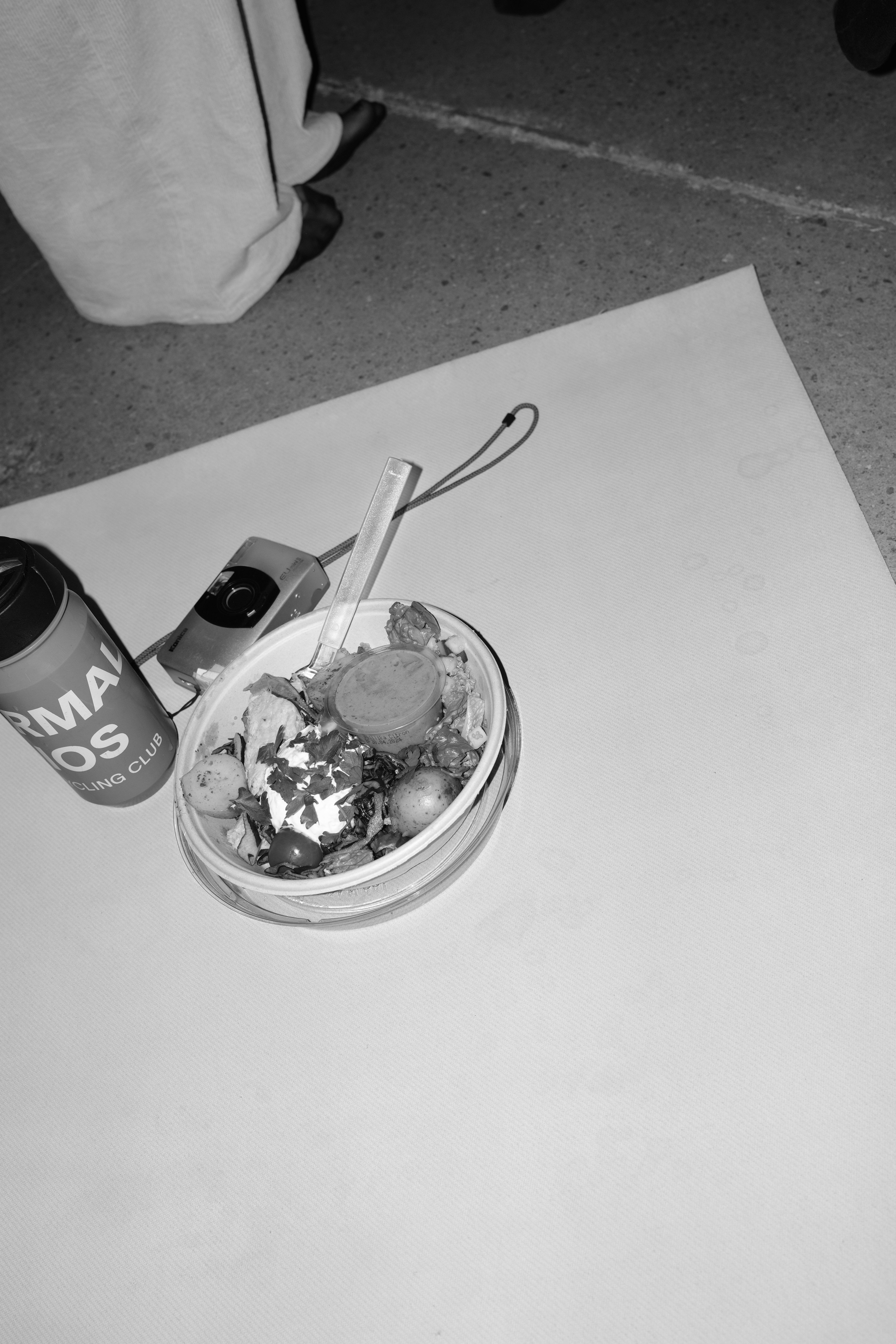 Glass bowl with ice cream and berries on white table with cycling club merchandise