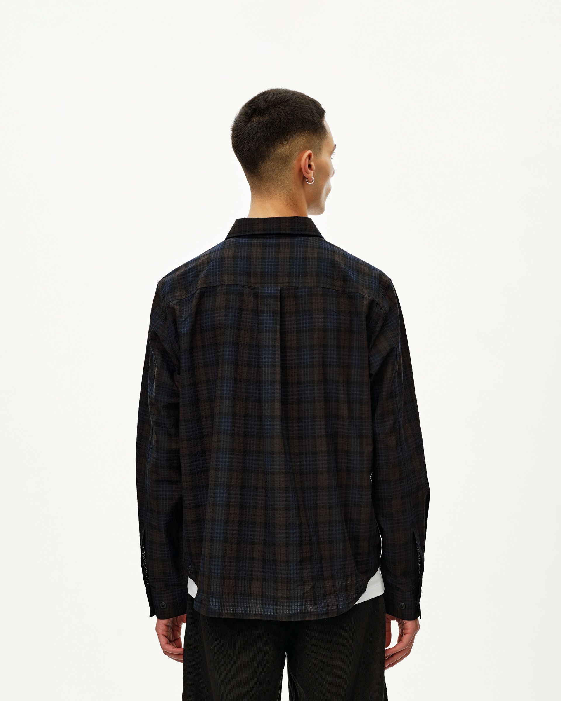 Dark Navy Off-Race Seersucker Shirt, rear view on model with dark plaid pattern