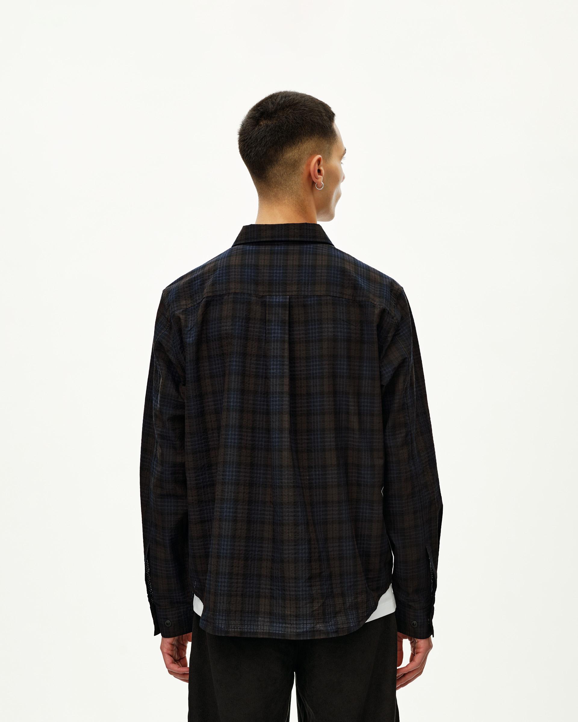 Dark Navy Off-Race Seersucker Shirt, rear view on model with dark plaid pattern