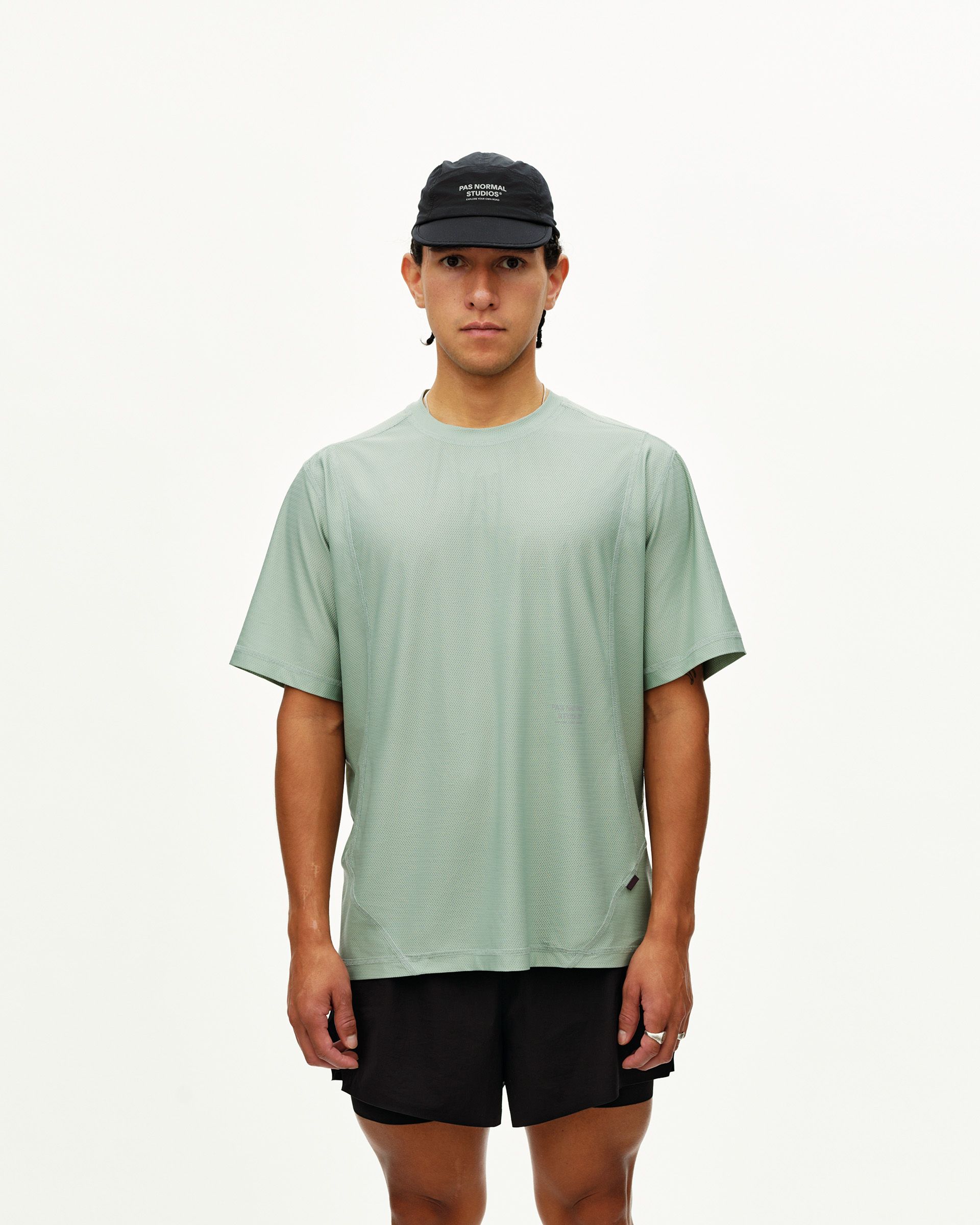 Green Sage Balance T-shirt on model, front view with textured fabric and curved hem seams