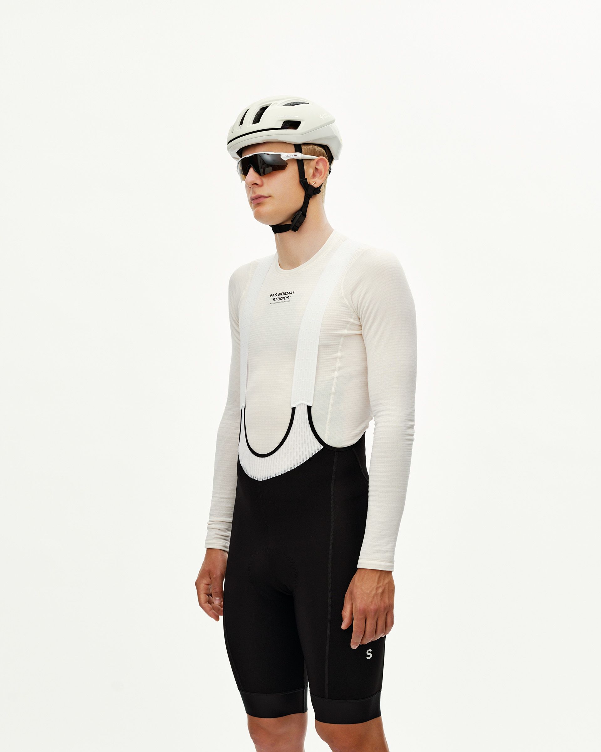 Black Mechanism Thermal cycling bibs on model, three-quarter front view with white mesh bib straps