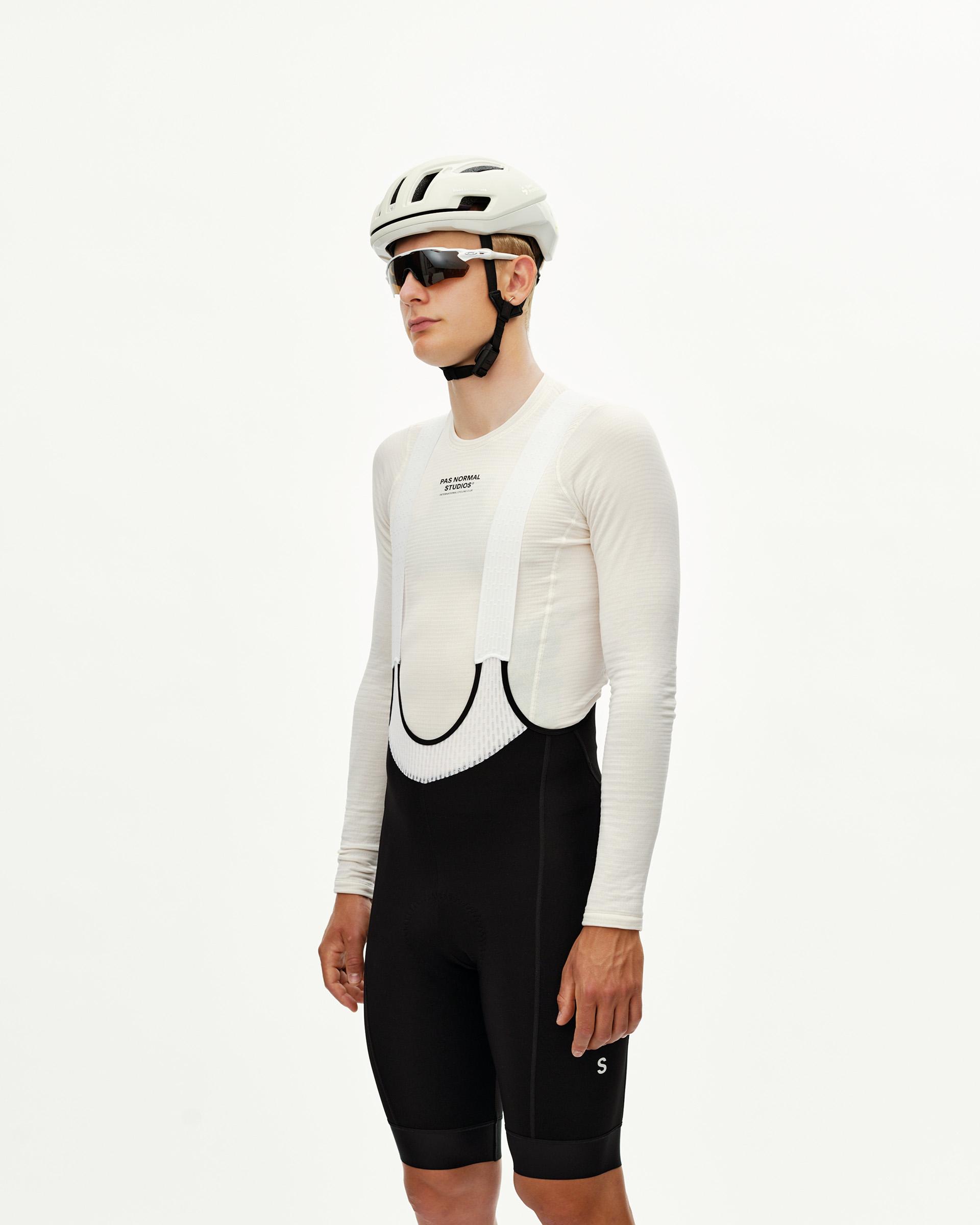 Black Mechanism Thermal cycling bibs on model, three-quarter front view with white mesh bib straps
