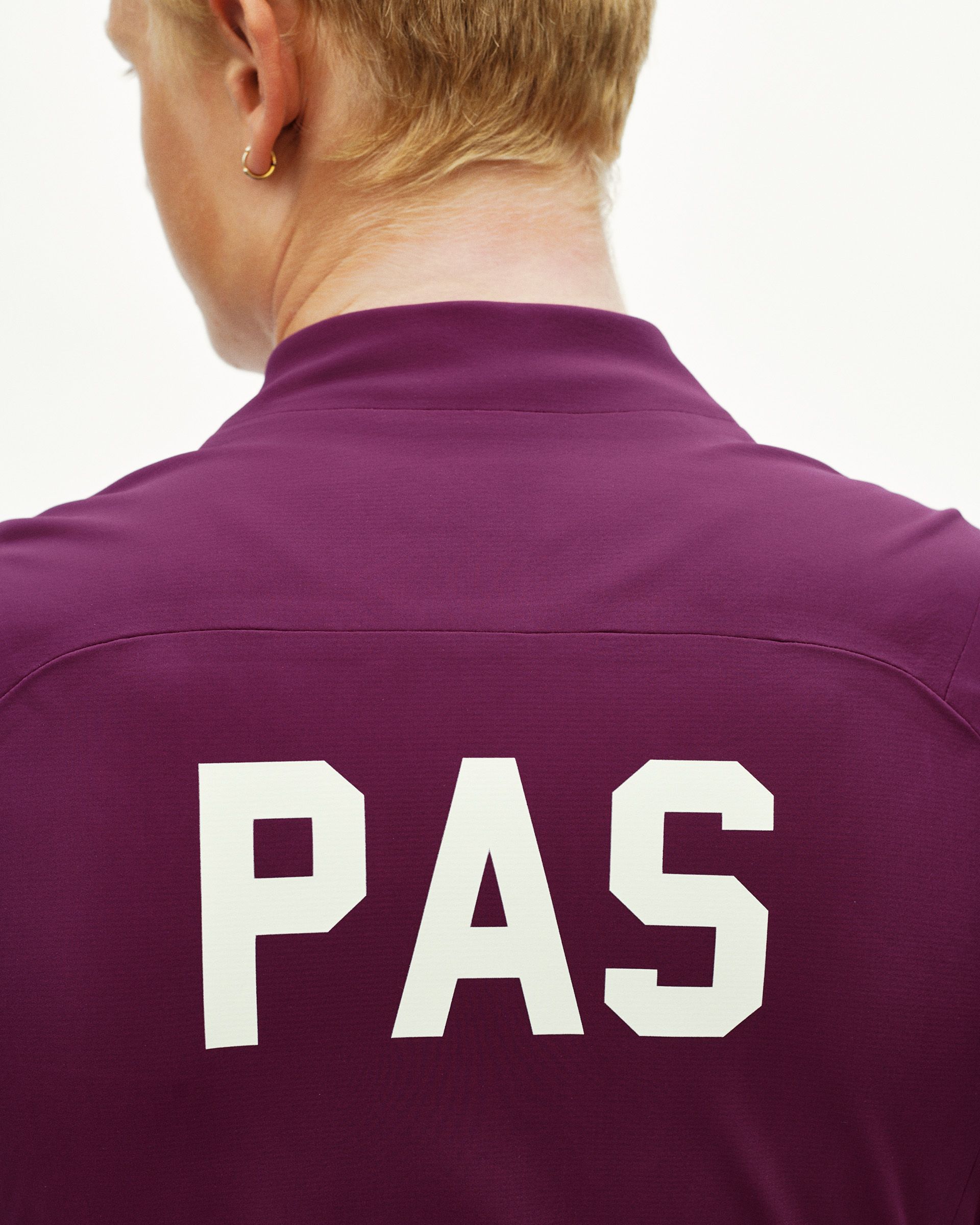 Dark Purple PAS Mechanism Thermal cycling jacket, rear detail on model with large white PAS back print