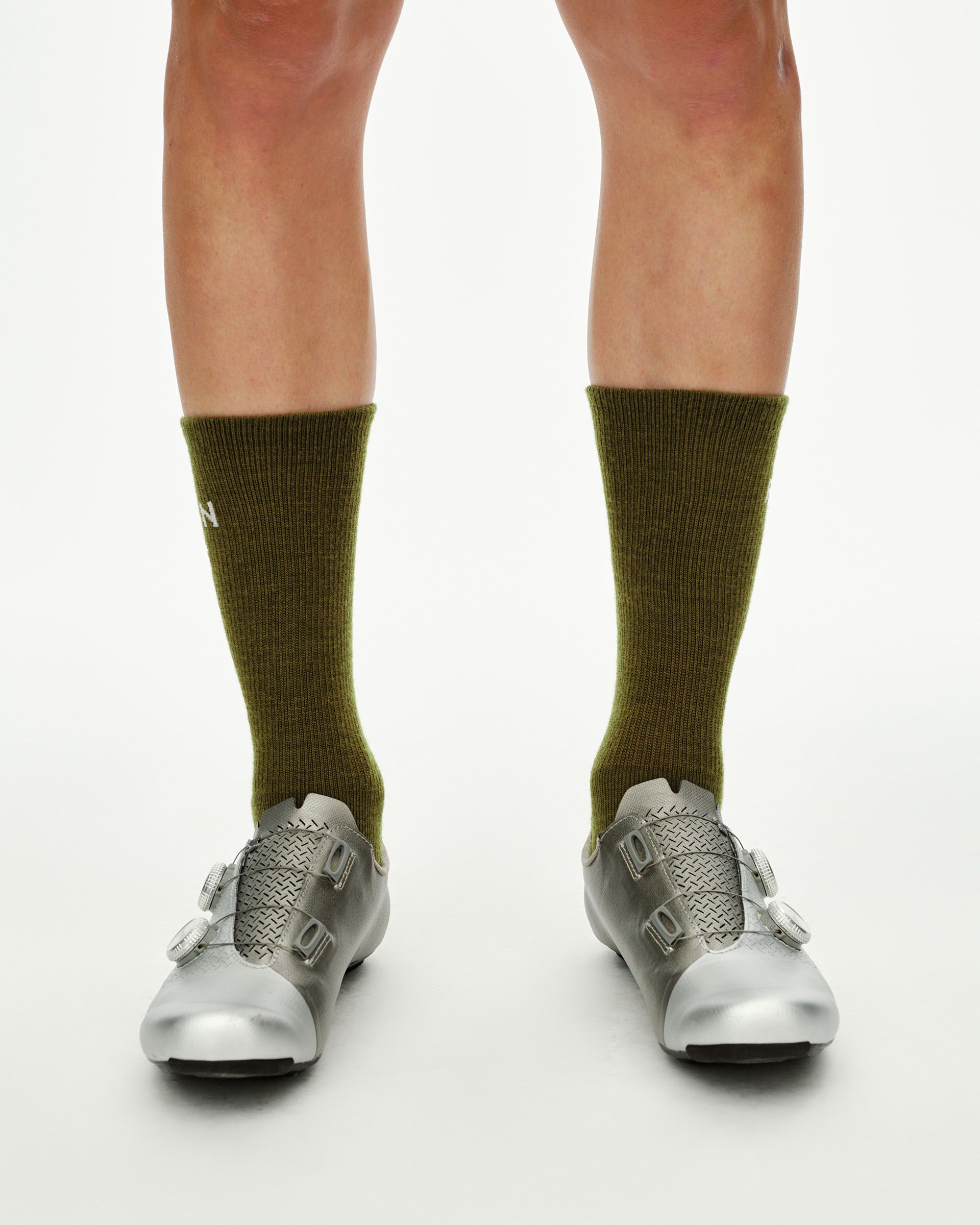 Khaki Green Deep Winter Wool cycling socks on model, front view showing mid-calf ribbed cuff