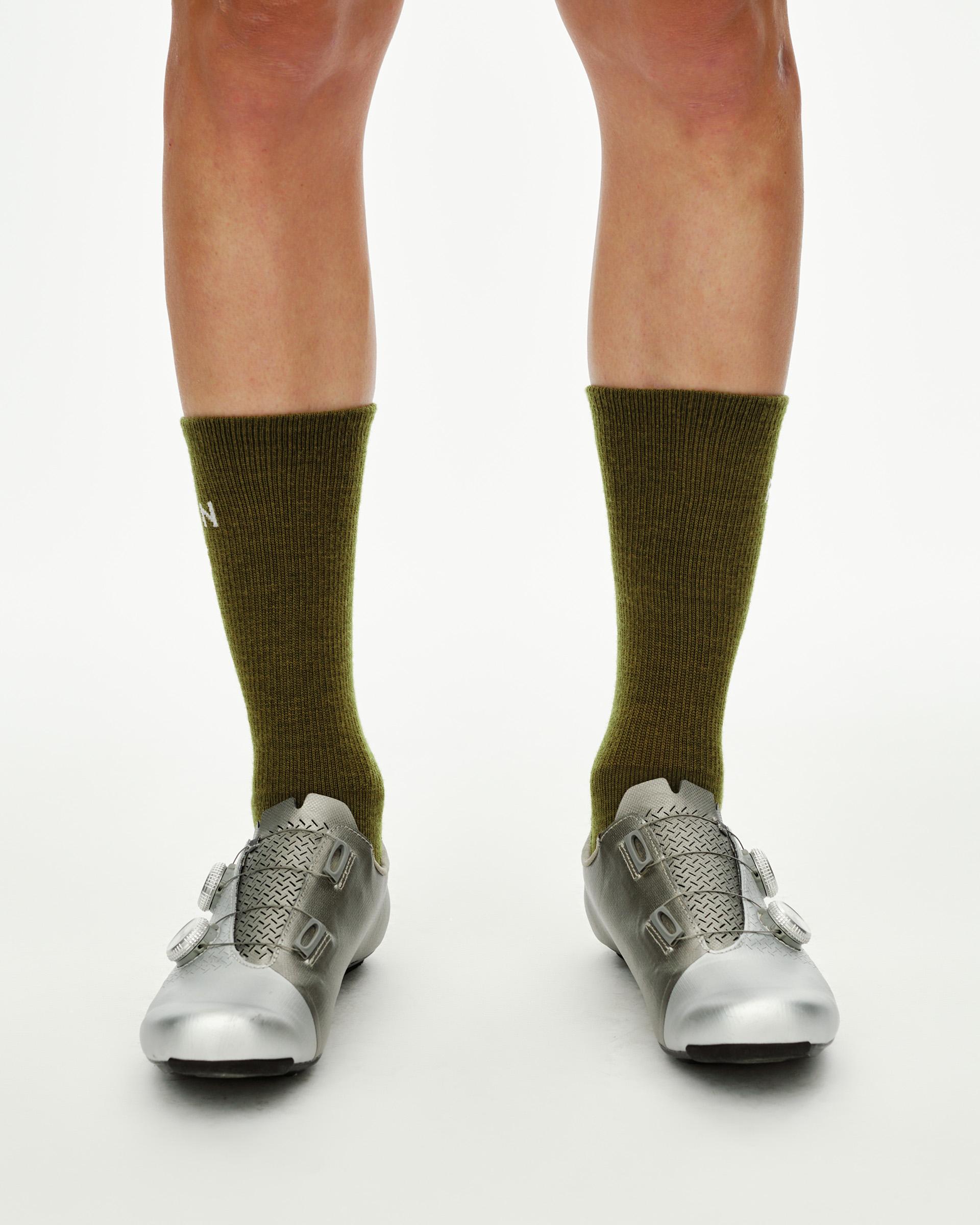 Khaki Green Deep Winter Wool cycling socks on model, front view showing mid-calf ribbed cuff