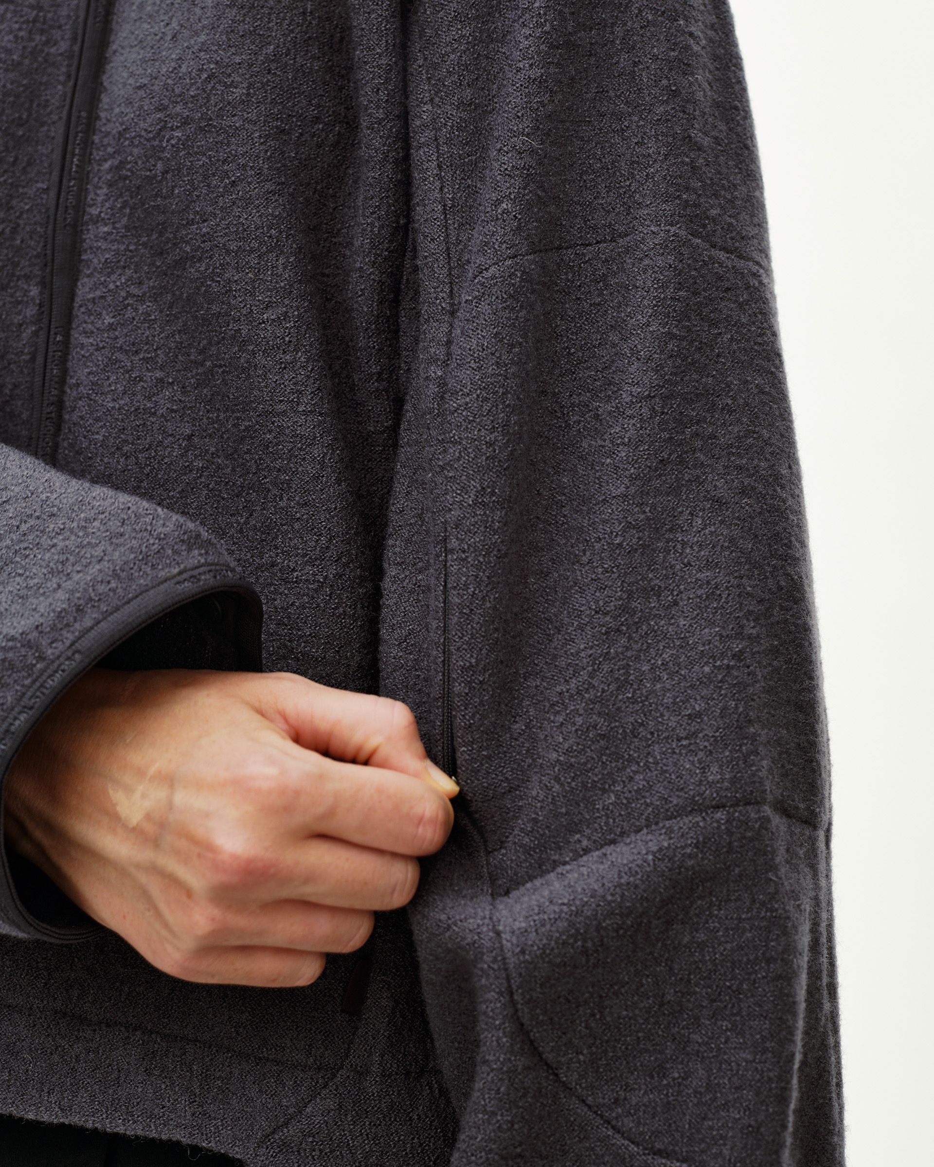Steel grey Off-Race Boiled Wool women's jacket, detail view on model showing side zip pocket