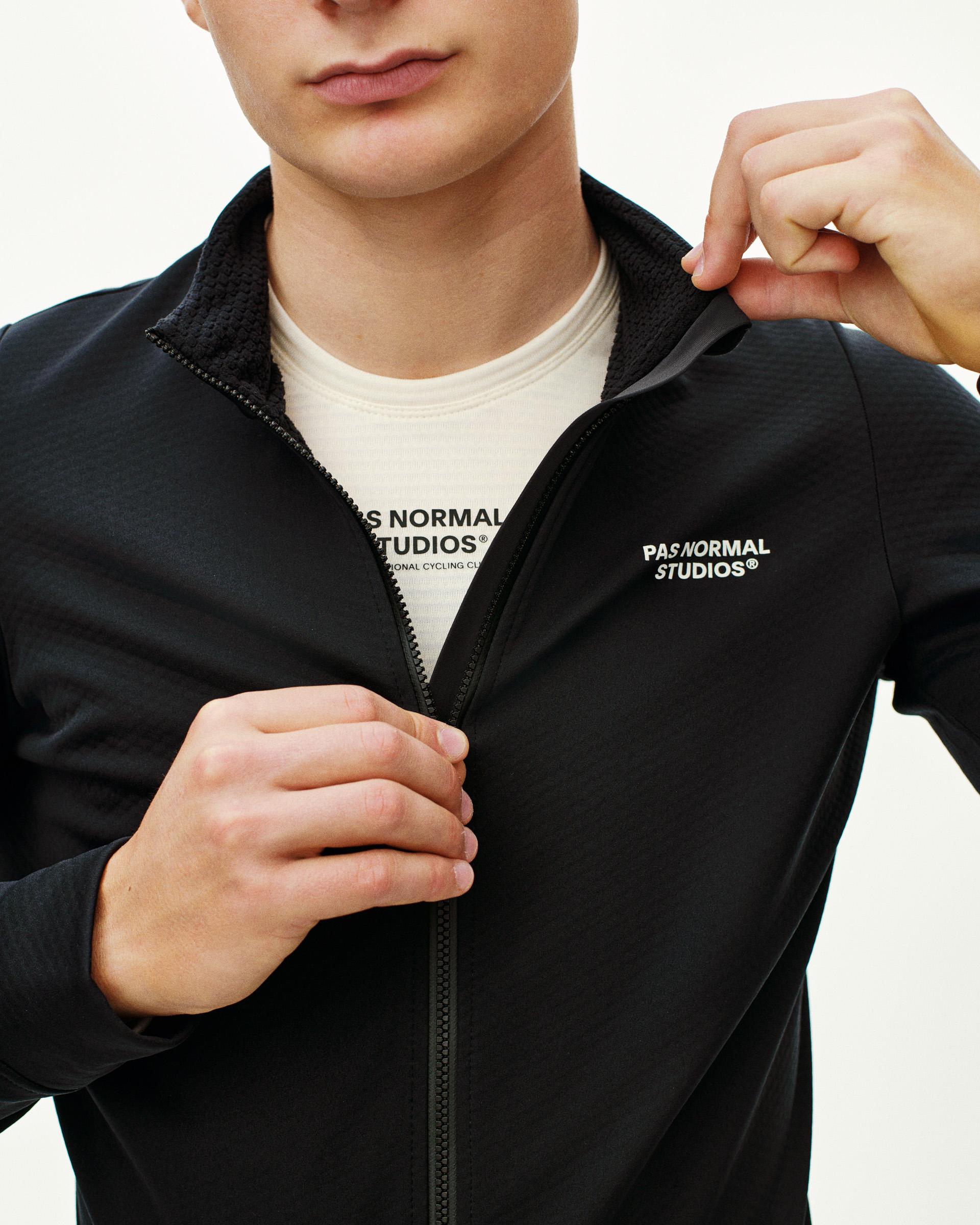 Black Essential Thermal long sleeve cycling jersey on model with white chest logo and full zip