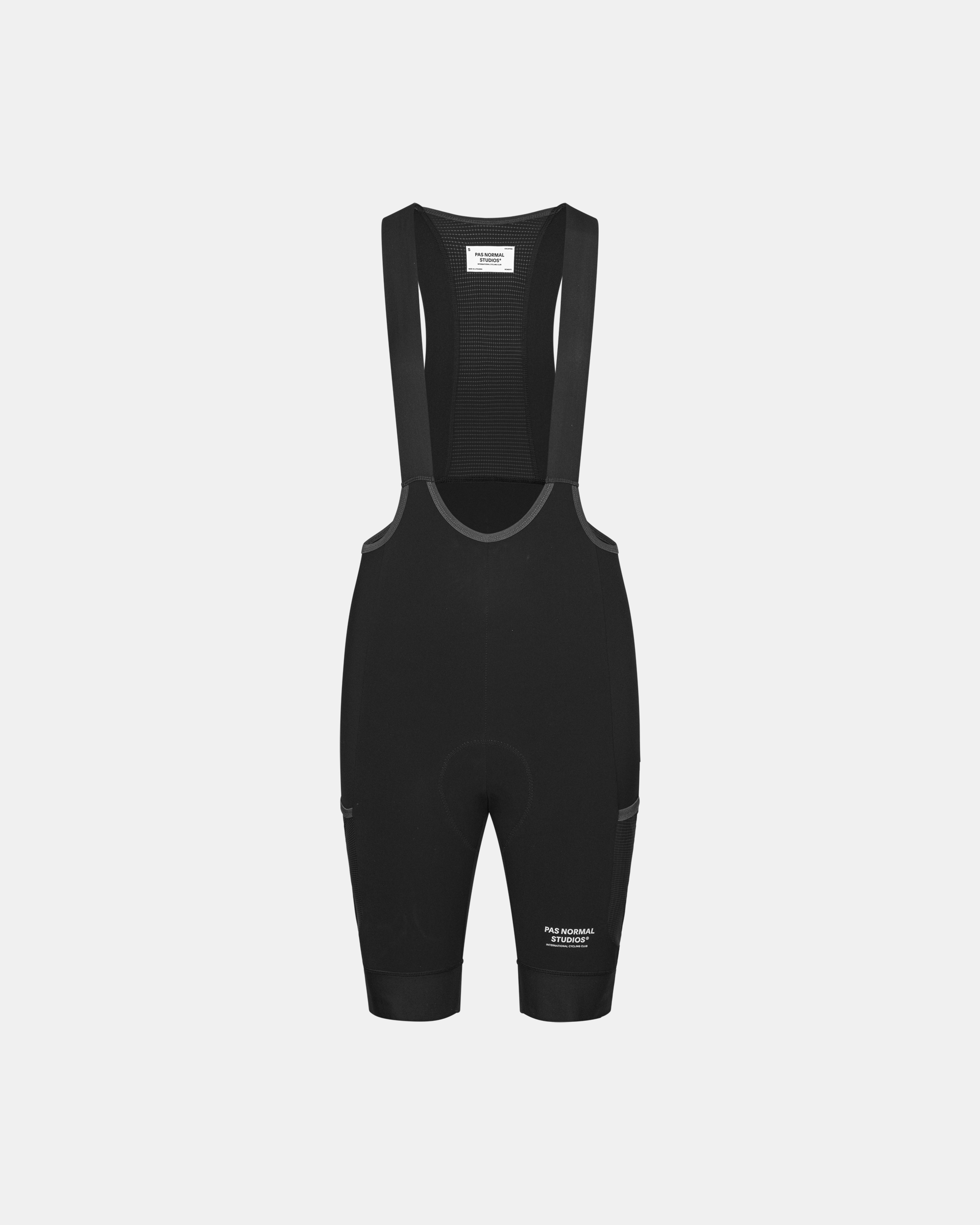 Black Escapism Cargo cycling bibs, front flat lay with mesh bib panel and cargo pockets