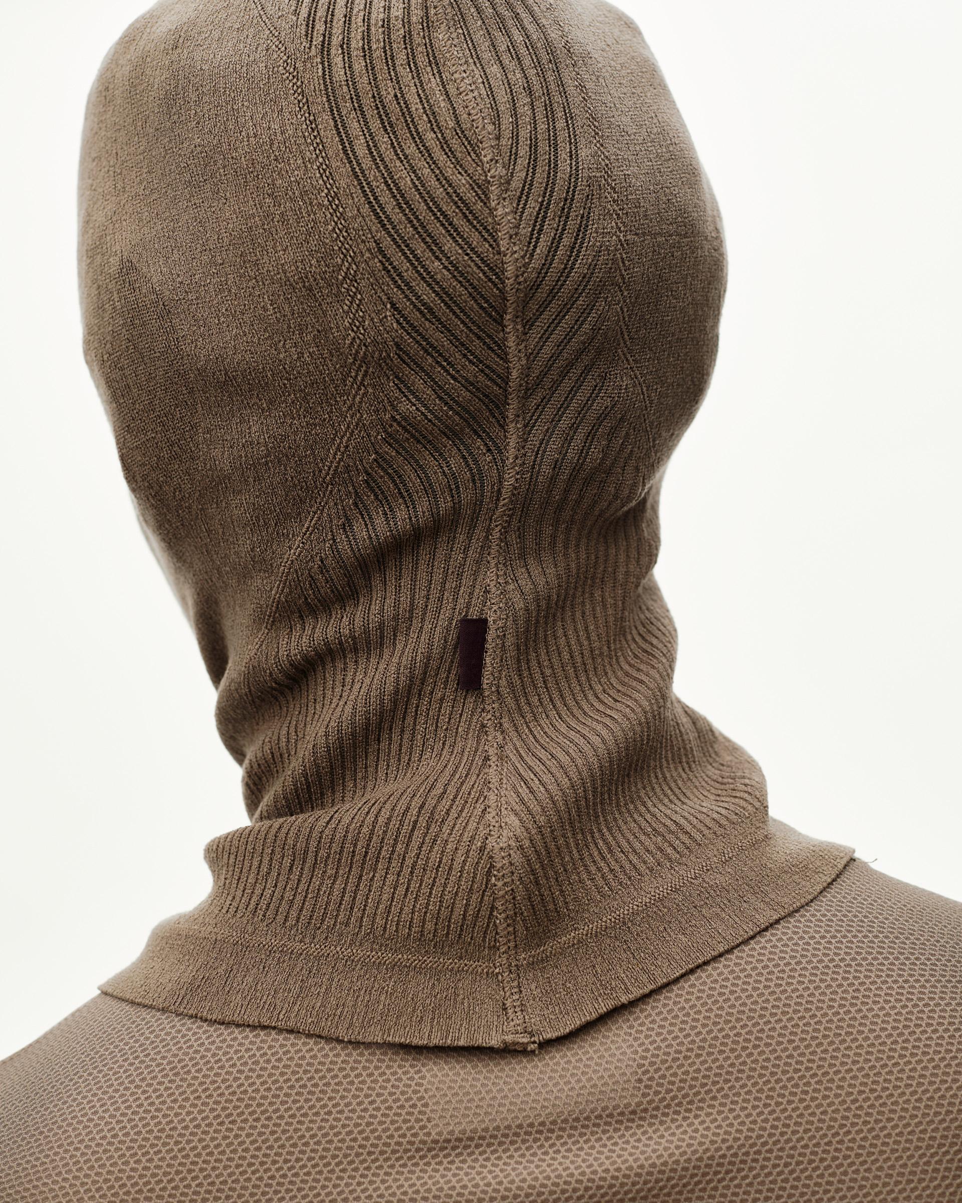 Stone Brown Balance balaclava, rear detail on model with ribbed neck and seamed knit crown