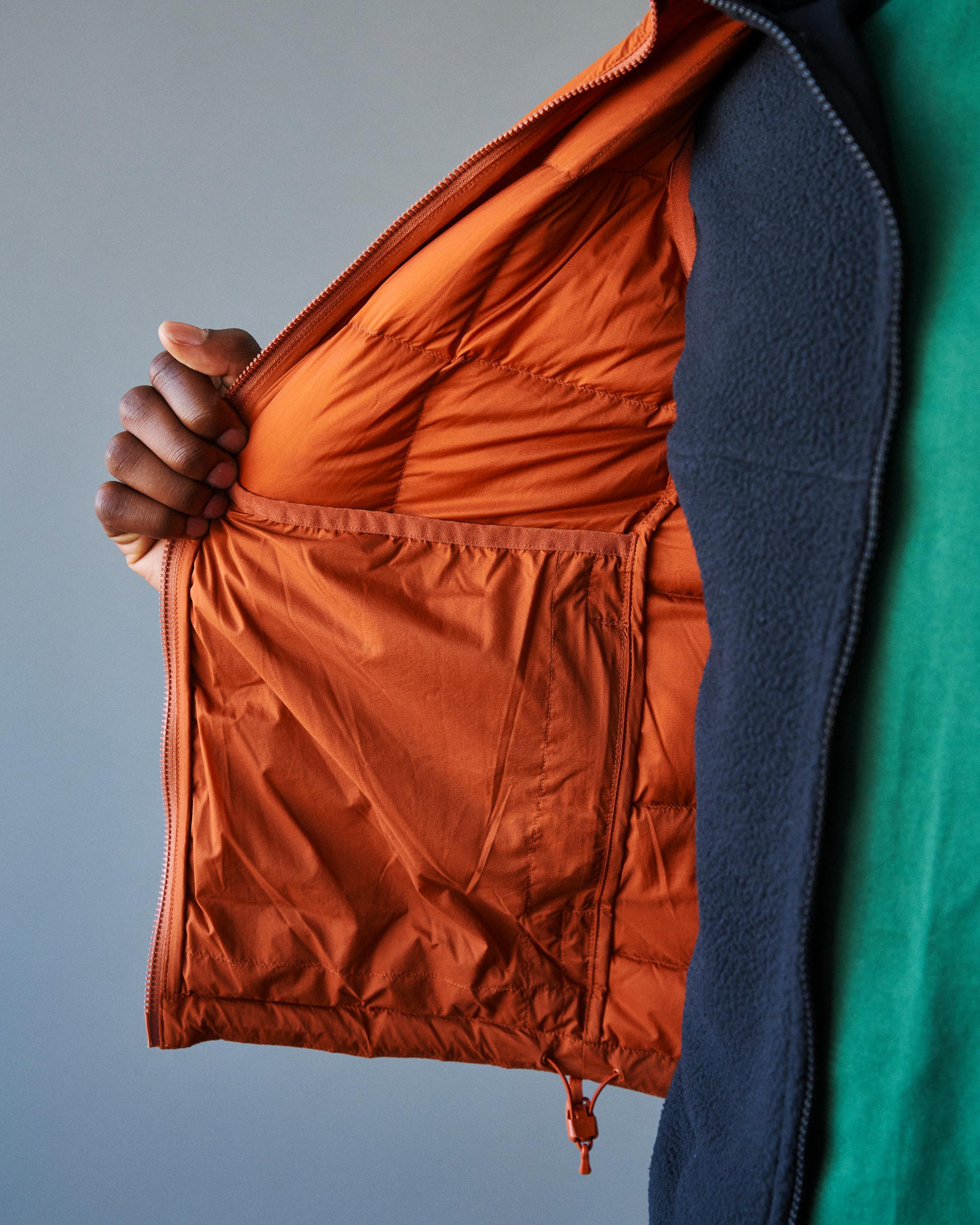 Orange Off-Race Down Vest on model showing orange inner lining and elastic waistband