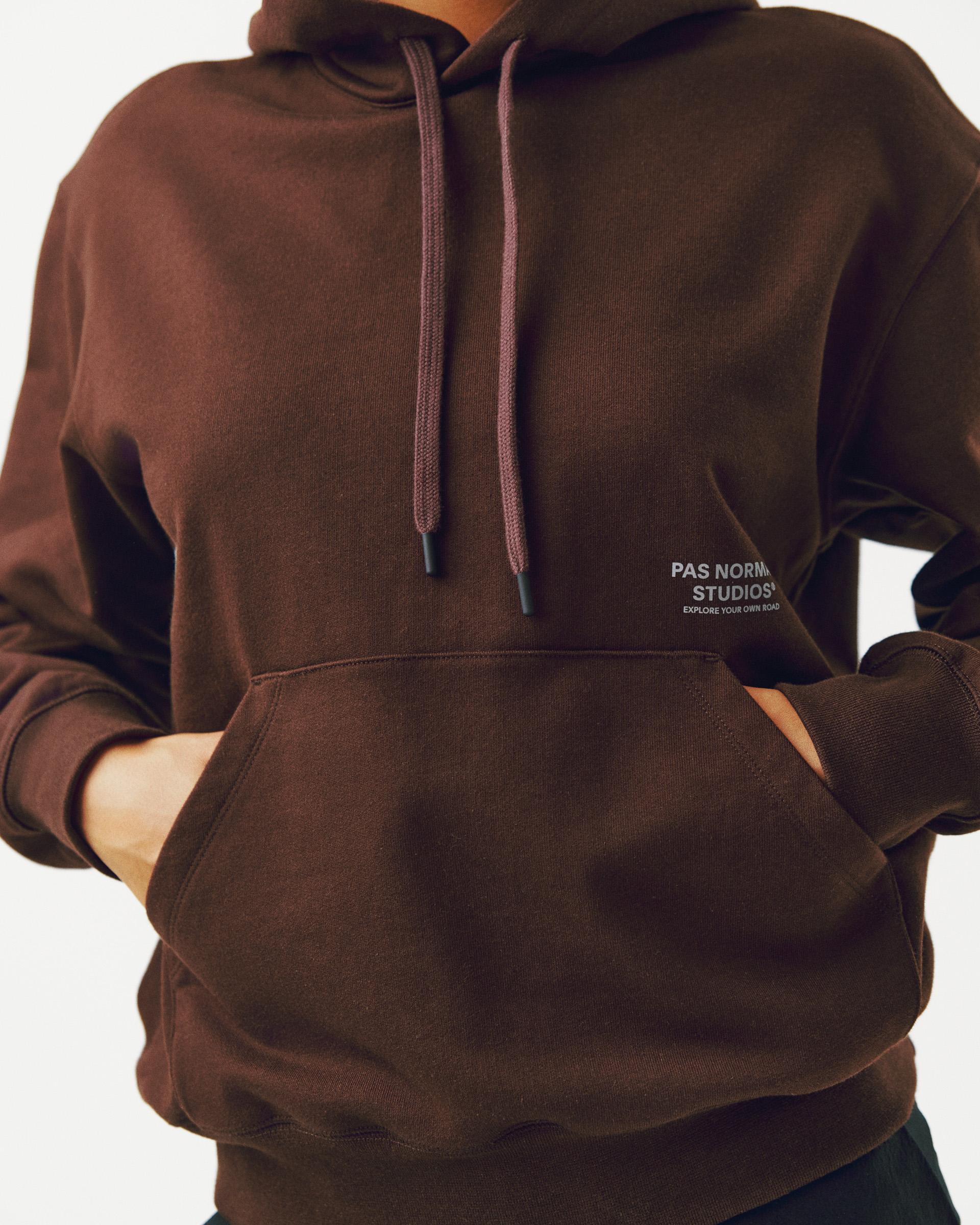 Light Brown Off-Race hoodie on model with kangaroo pocket and drawstring hood