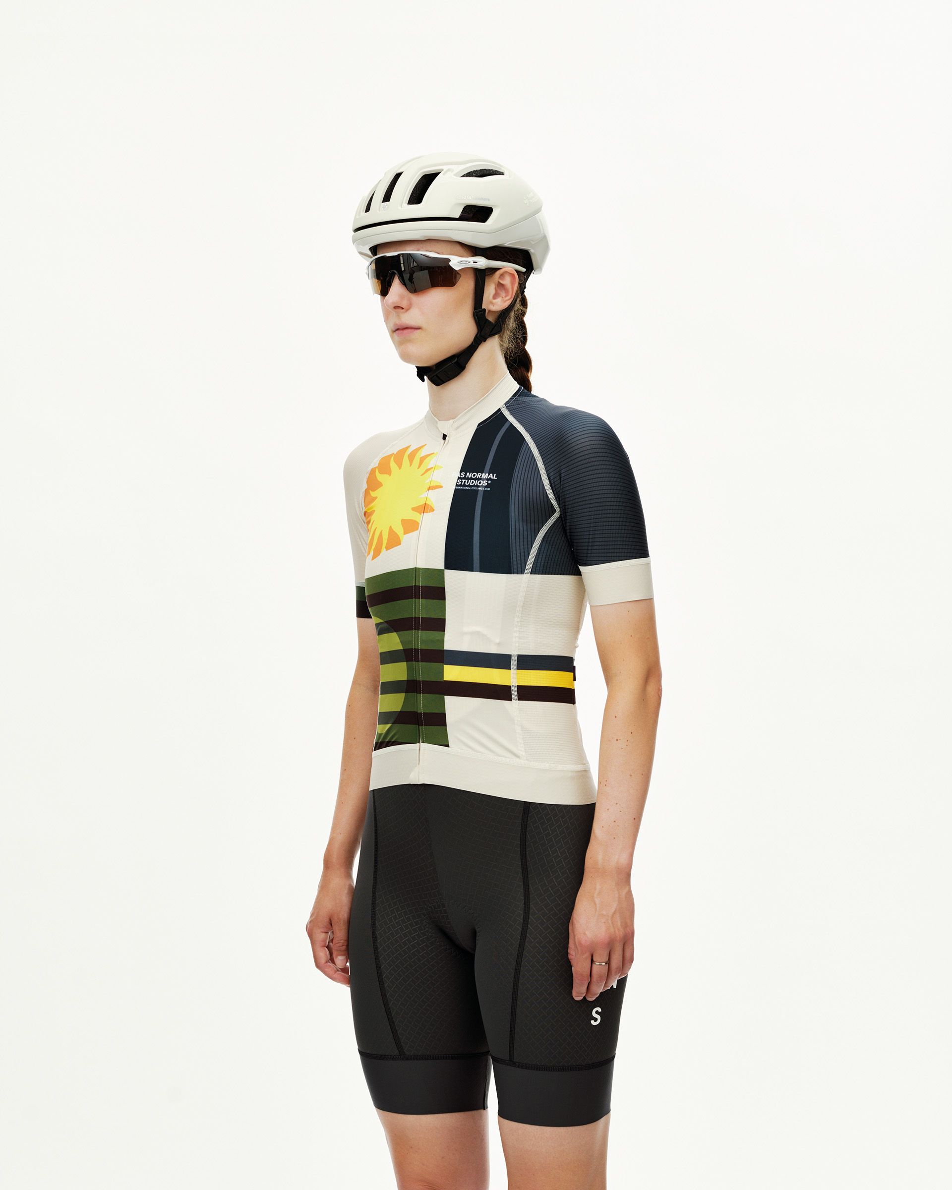 International Sand Mechanism women's cycling jersey on model, three-quarter front view with sun and stripe graphic print