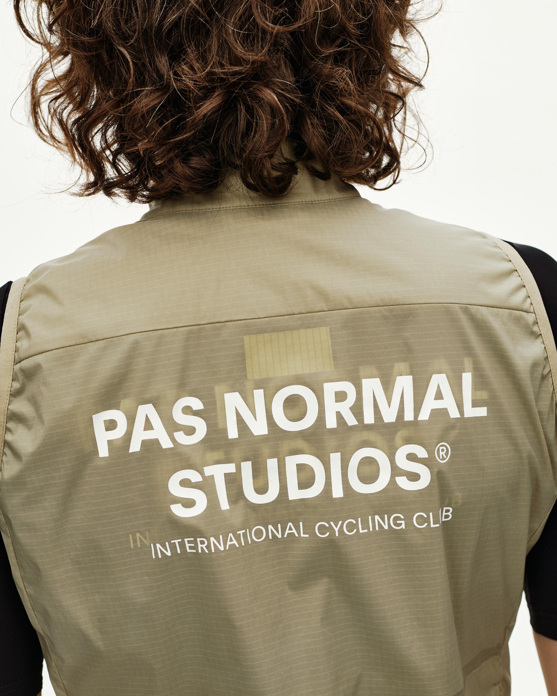 Grey Sage Essential Insulated cycling gilet on model, rear view with large white back print