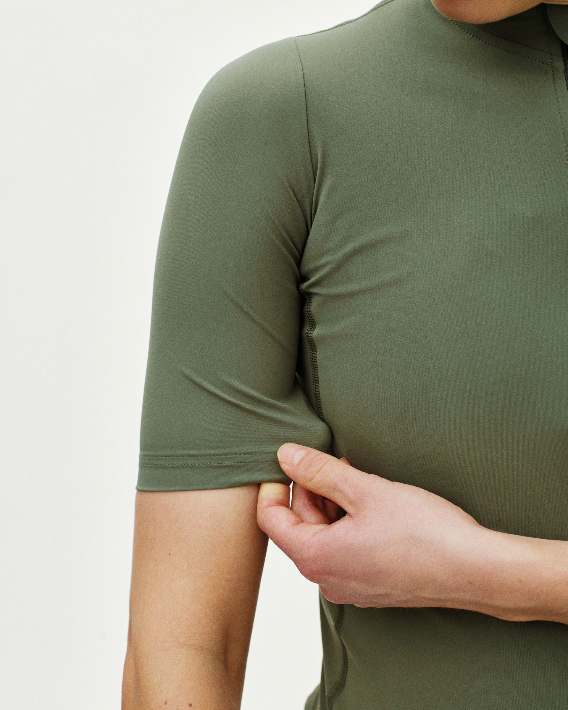 Green Essential cycling jersey on model showing side seam detail