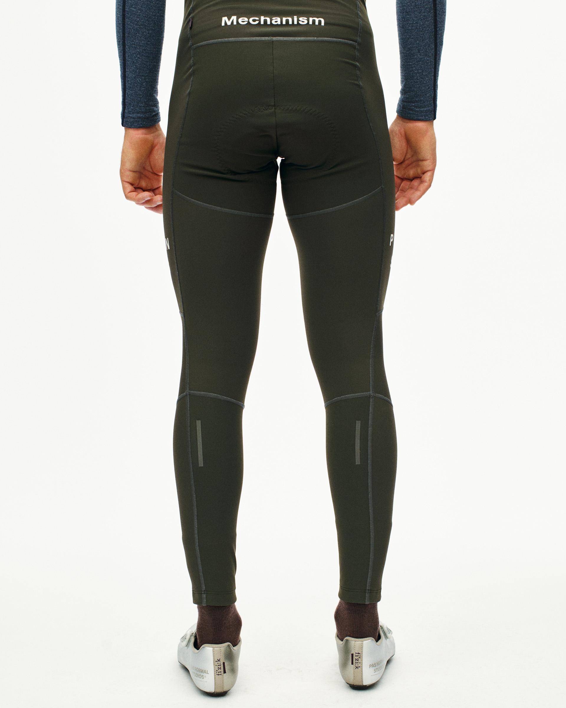 Dark Olive Mechanism Deep Winter Long bibs, rear view on model with reflective calf details