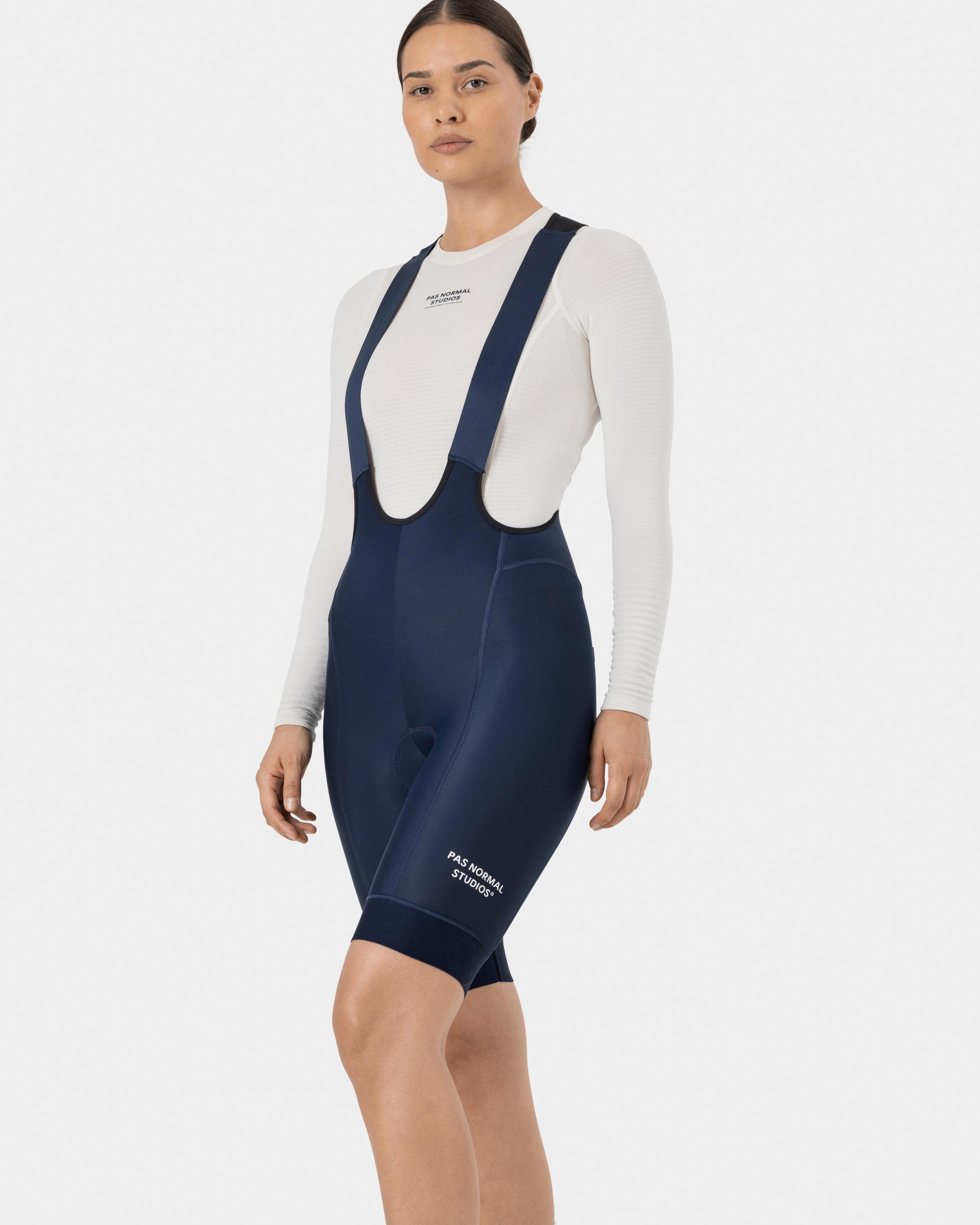 Navy Essential Thermal cycling bibs on model with white long sleeve base layer