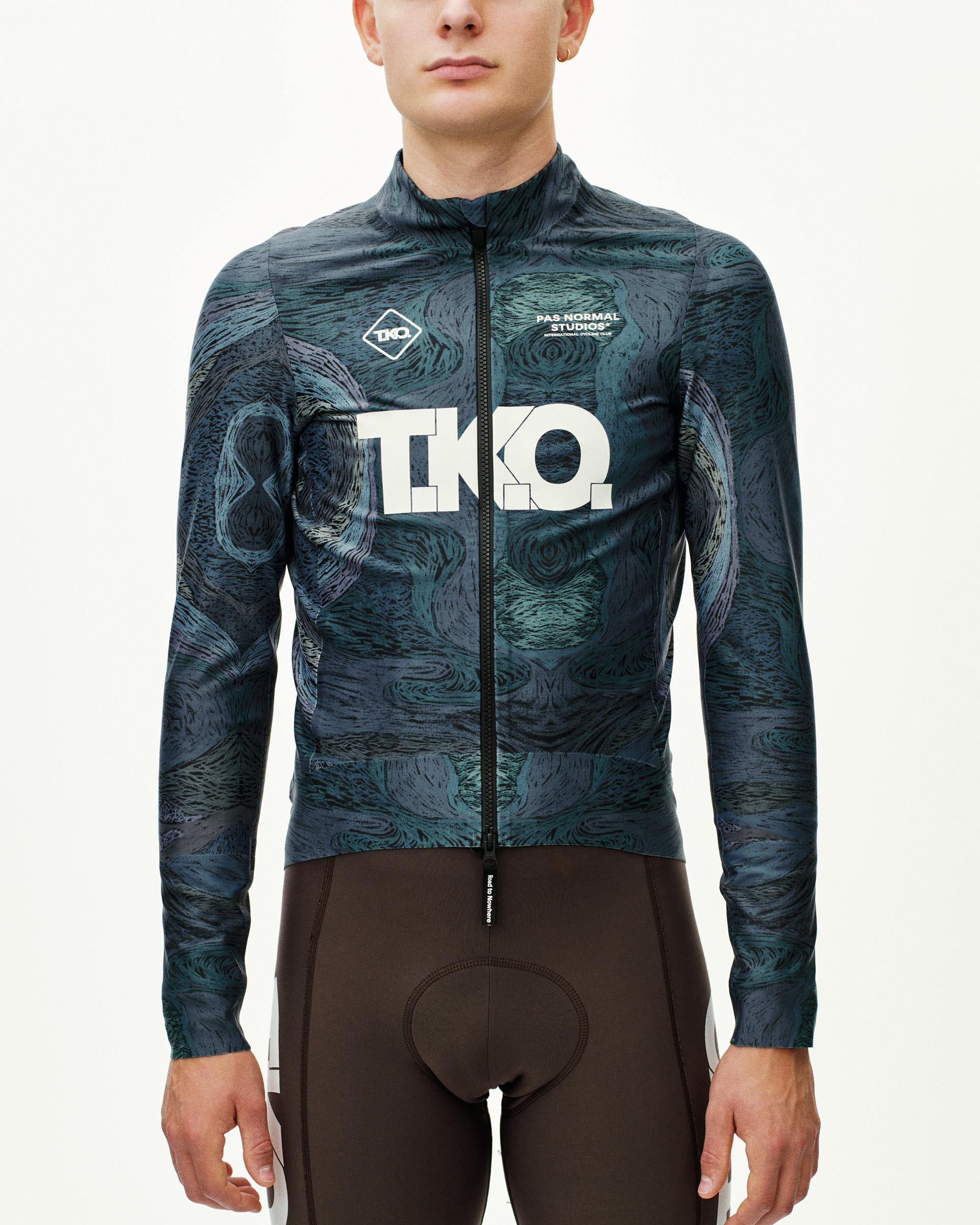 Dark Multi T.K.O. Mechanism Thermal cycling jacket on model, front view with allover swirl print and white chest logo