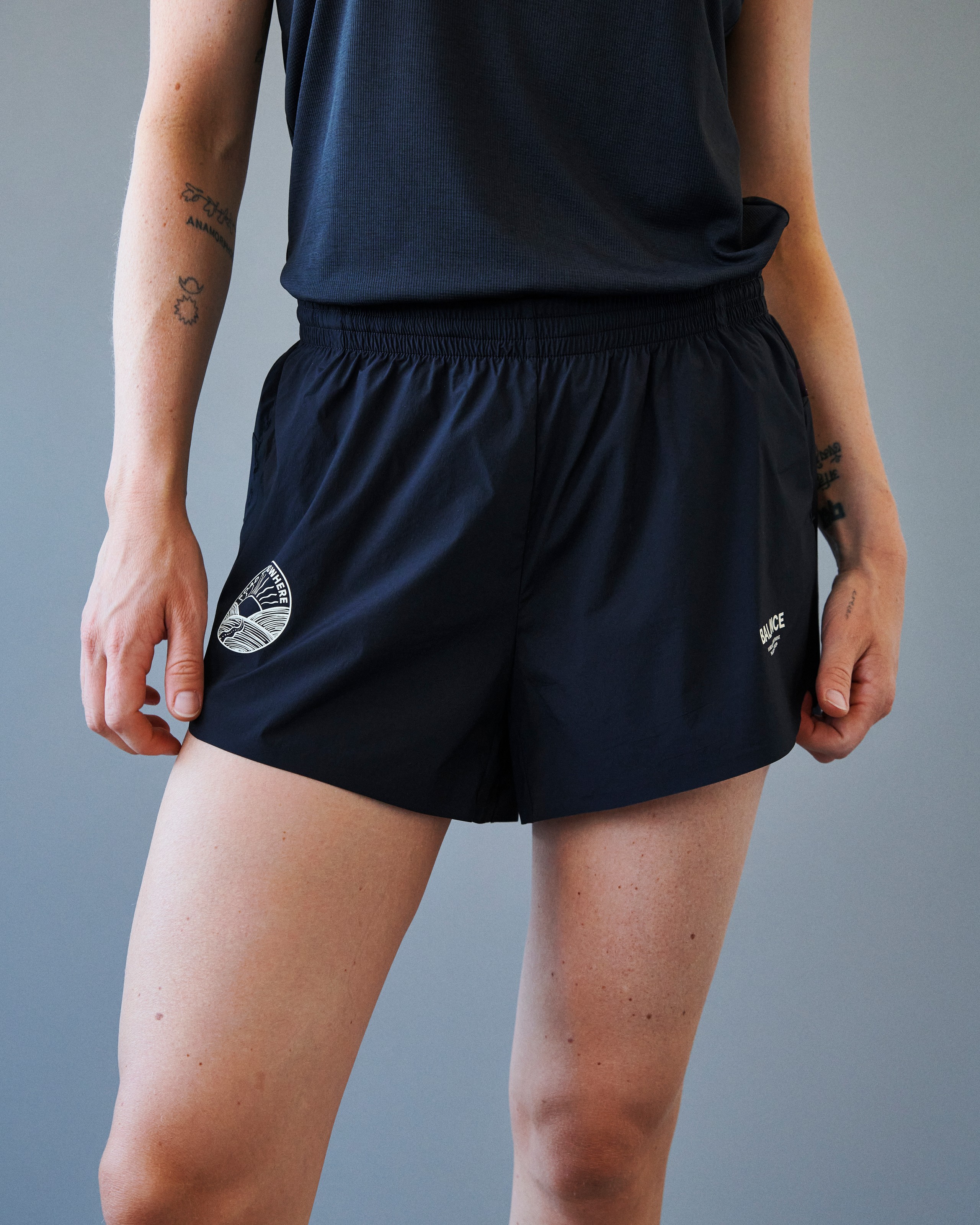 Black Balance shorts on model with elastic waistband and white logo print