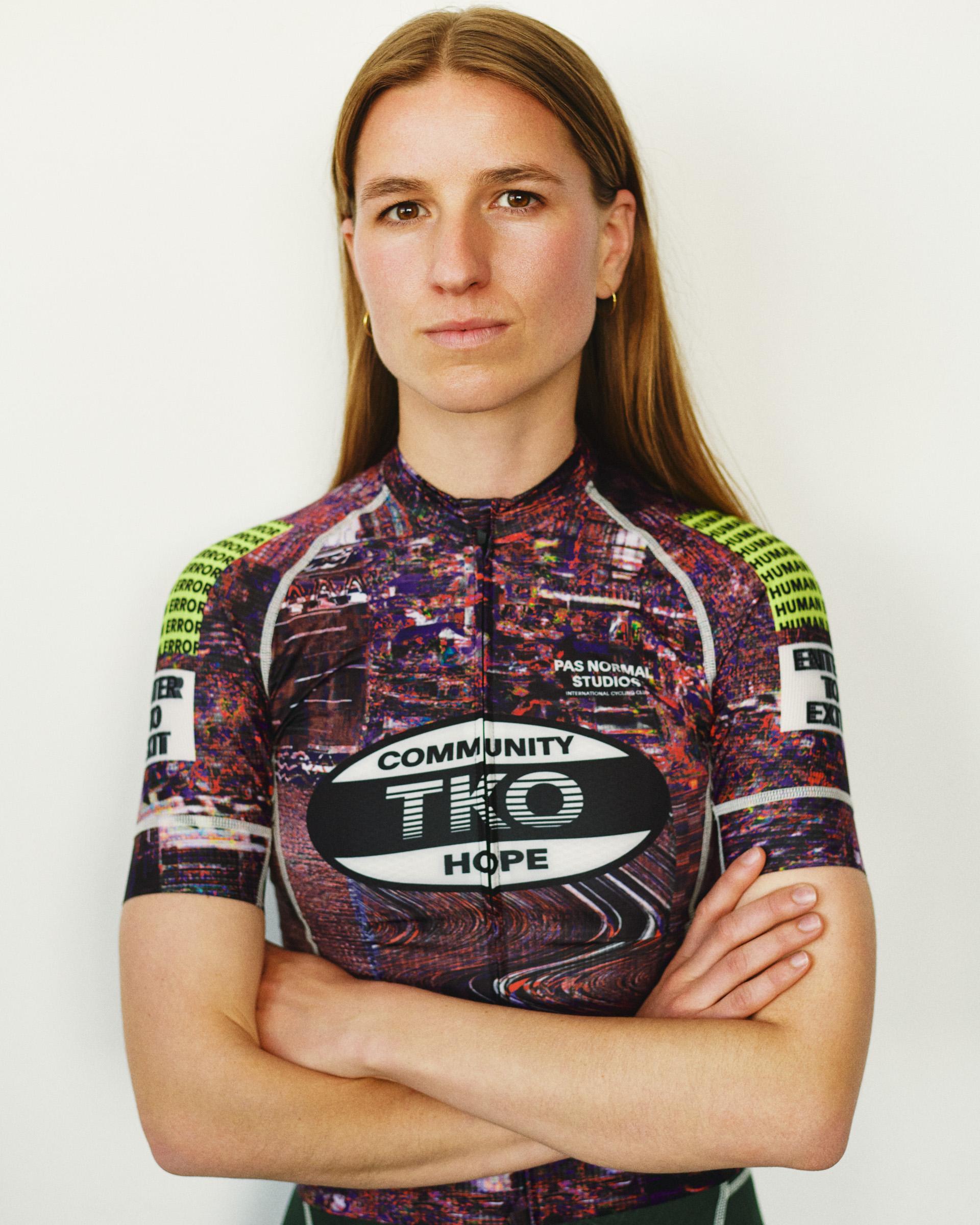Human Error Pink T.K.O. Mechanism women's cycling jersey on model, front view with allover graphic print and TKO chest logo
