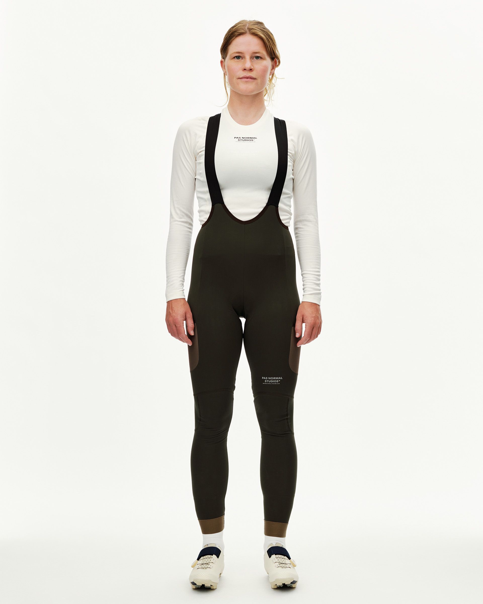 Dark Olive Escapism Long Cargo cycling bibs on model, front view with black shoulder straps and contrast panels