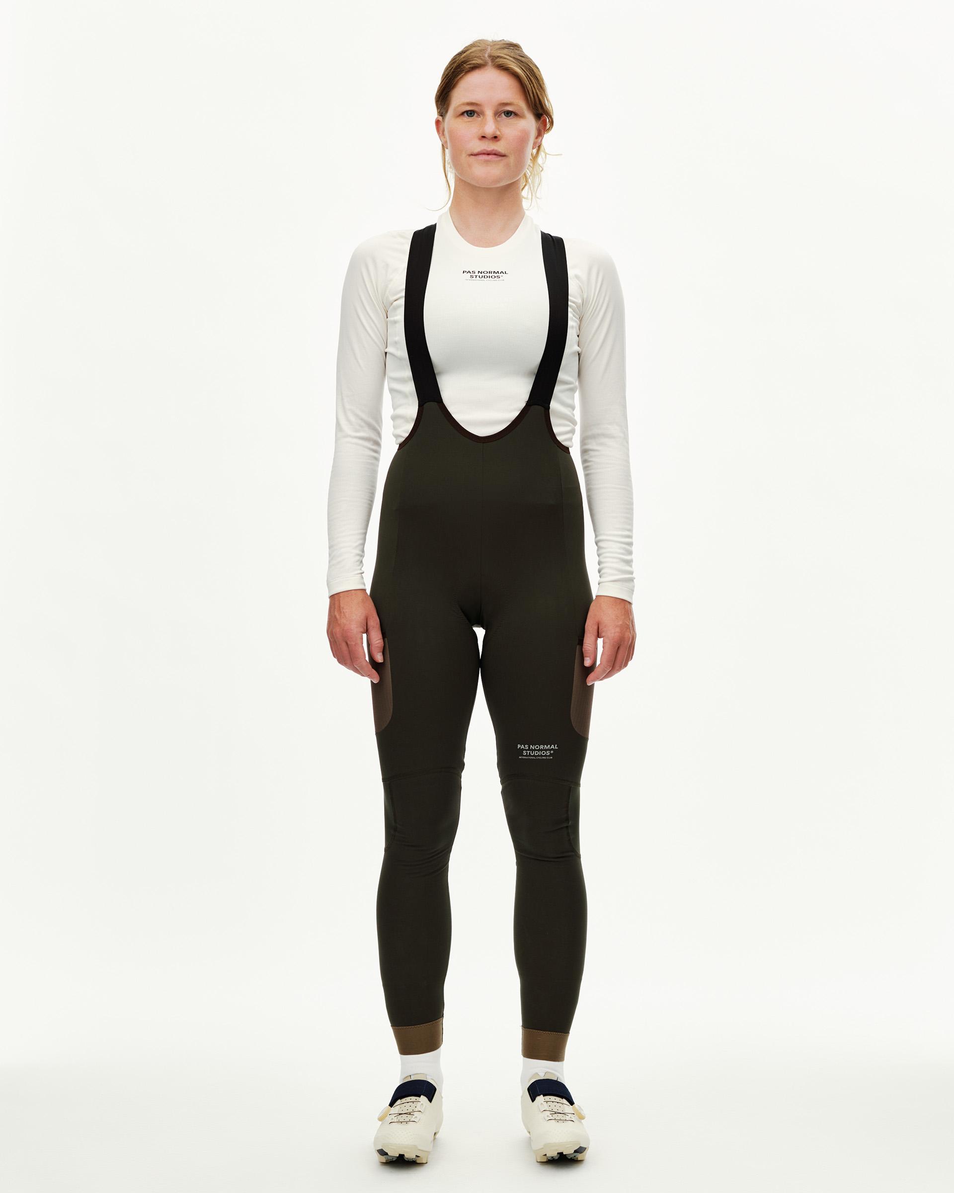 Dark Olive Escapism Long Cargo cycling bibs on model, front view with black shoulder straps and contrast panels