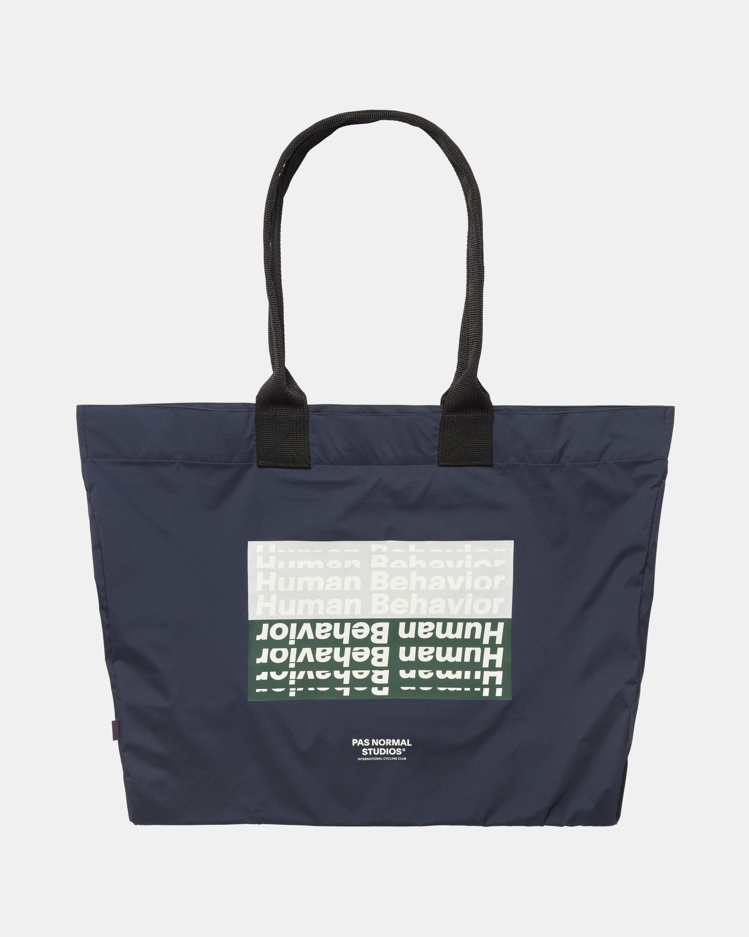 Navy T.K.O. Shield tote bag, front flat lay with repeated Human Behavior graphic print