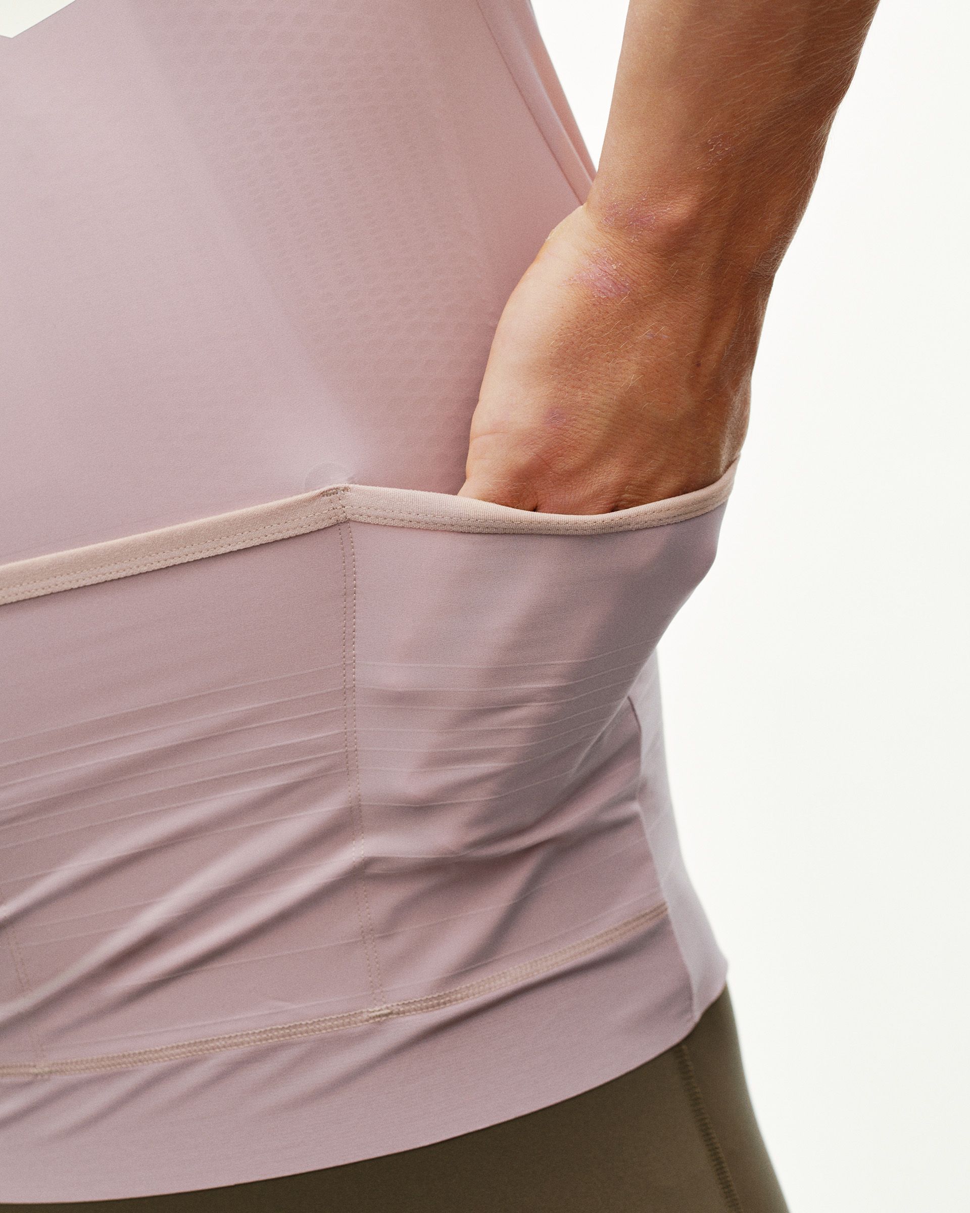 Taupe Rose PAS Mechanism Pro cycling jersey, rear detail on model showing back pocket opening